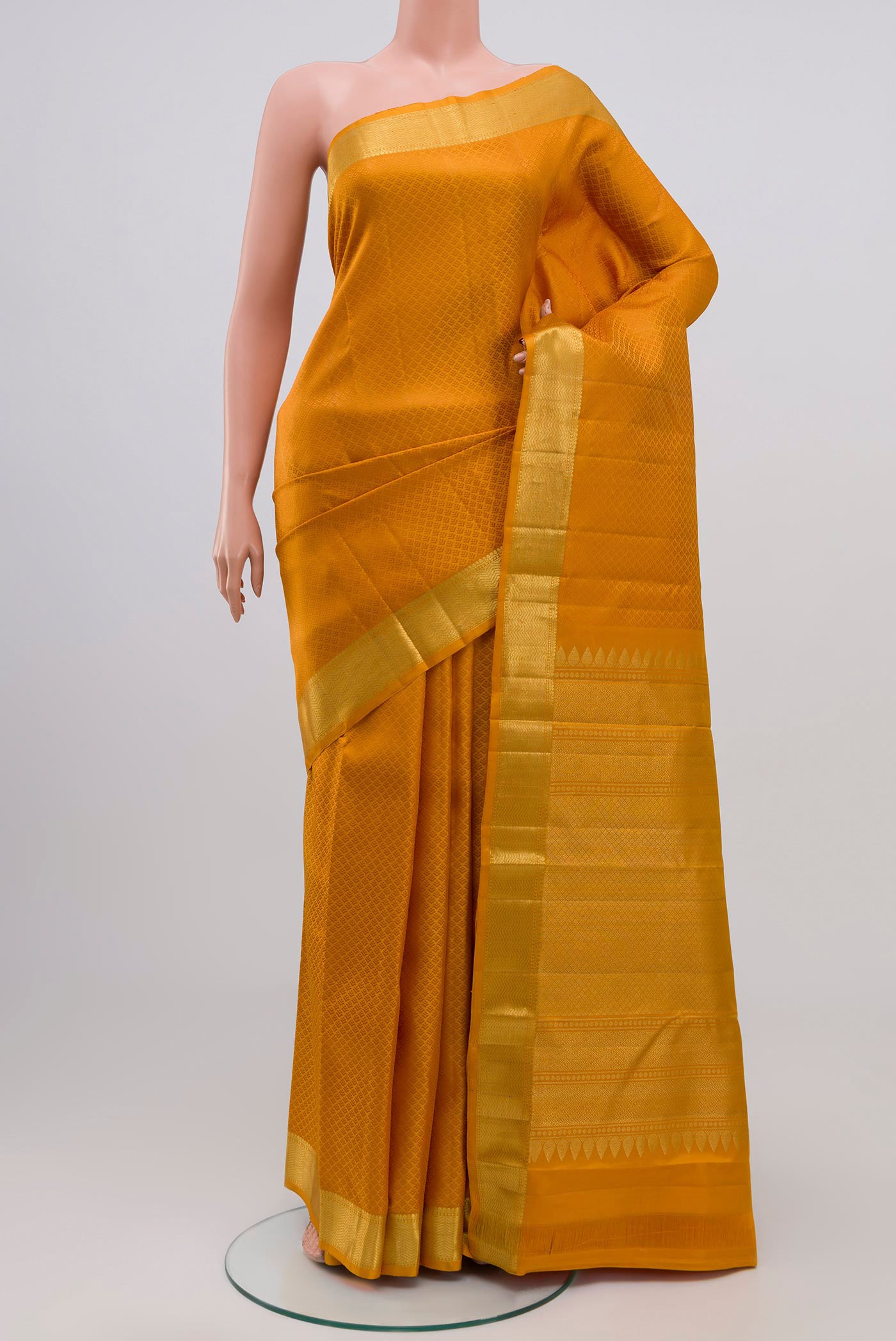 Yellow Kanjivaram Silk Saree with Jacquard design on the body and Zari Border.  displayed on a mannequin