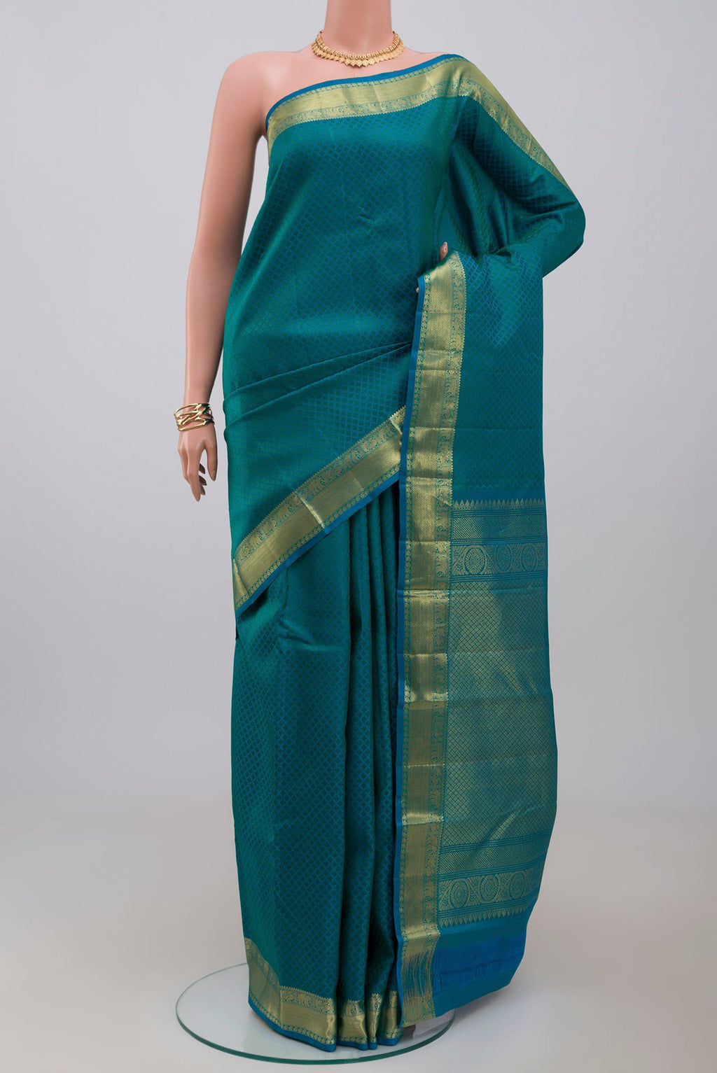 Blue Kanjivaram Saree with Jacquard design on the body and Zari Border.  displayed on a mannequin