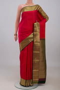 Red Kanjivaram Silk Saree with Jacquard design on the body and Zari Border.  displayed on a mannequin