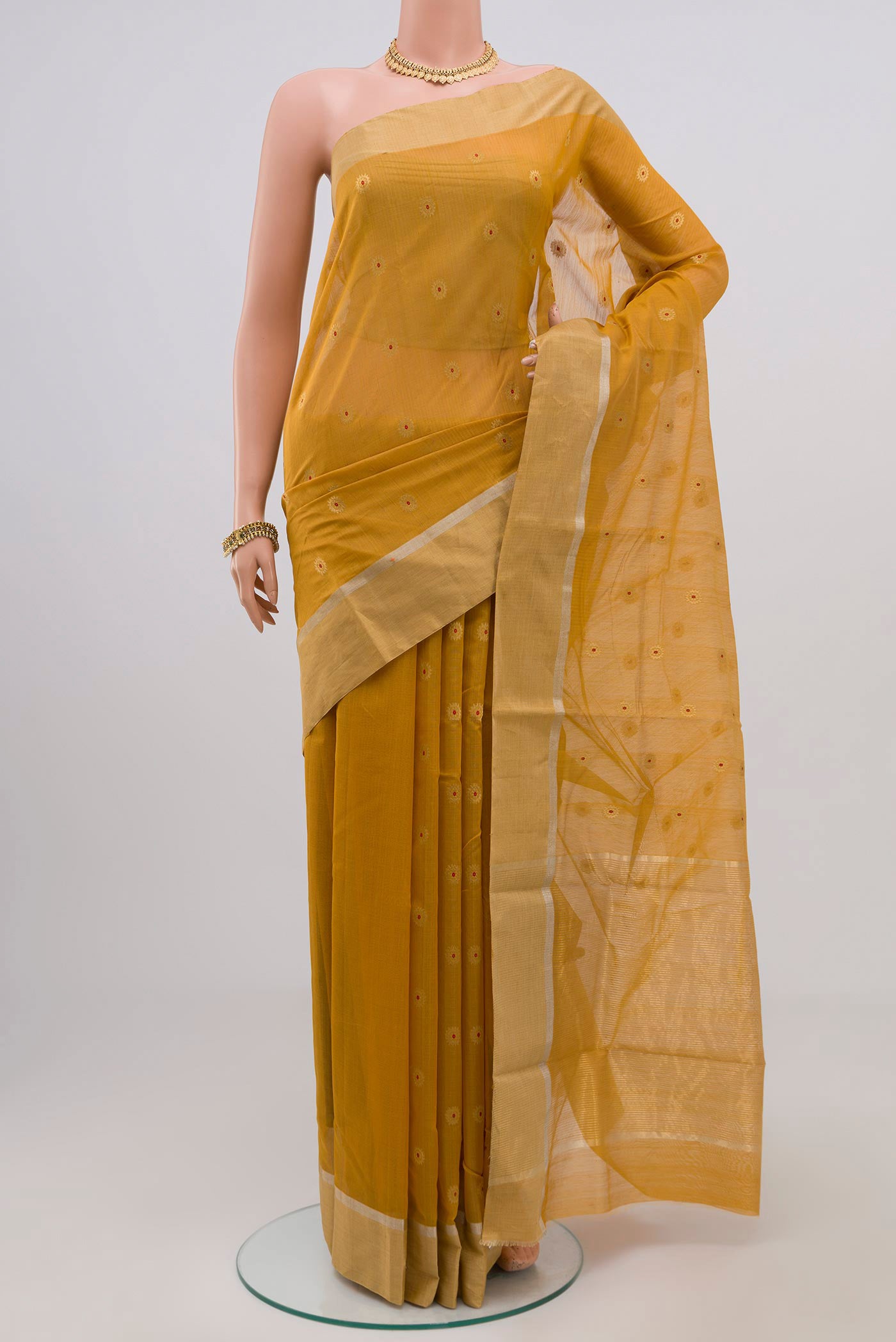 Yellow Chanderi Silk Cotton Saree with Zari Butta on the body and Zari Border.  displayed on a mannequin