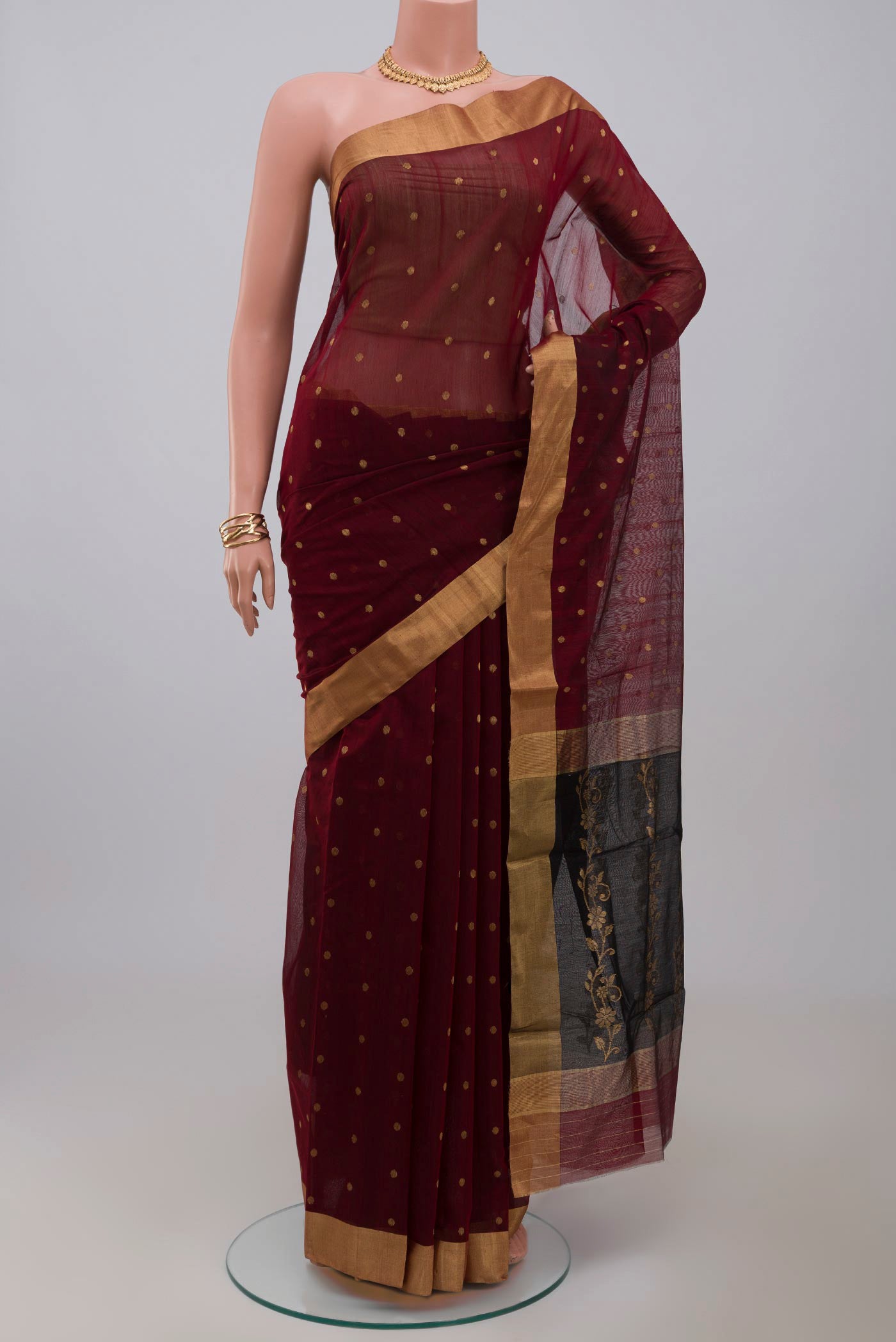 Maroon Chanderi Silk Cotton Saree with Zari Butta on the body and Zari Border.  displayed on a mannequin