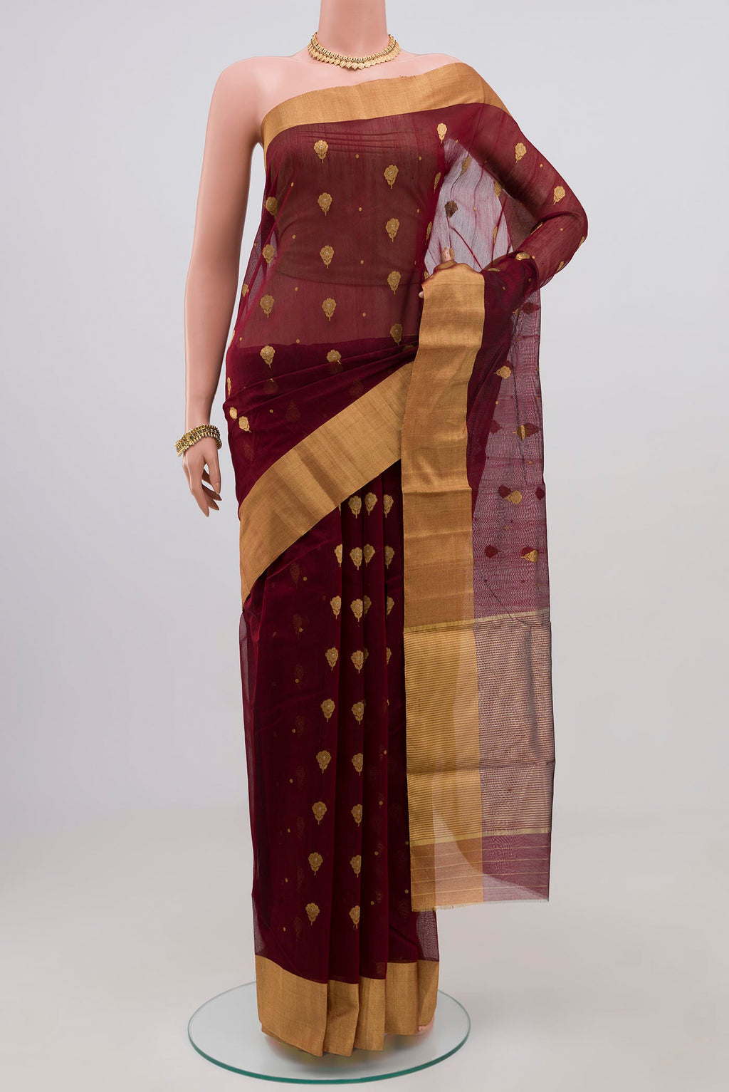 Maroon Chanderi Silk Cotton Saree with Zari Butta on the body and Zari Border.  displayed on a mannequin