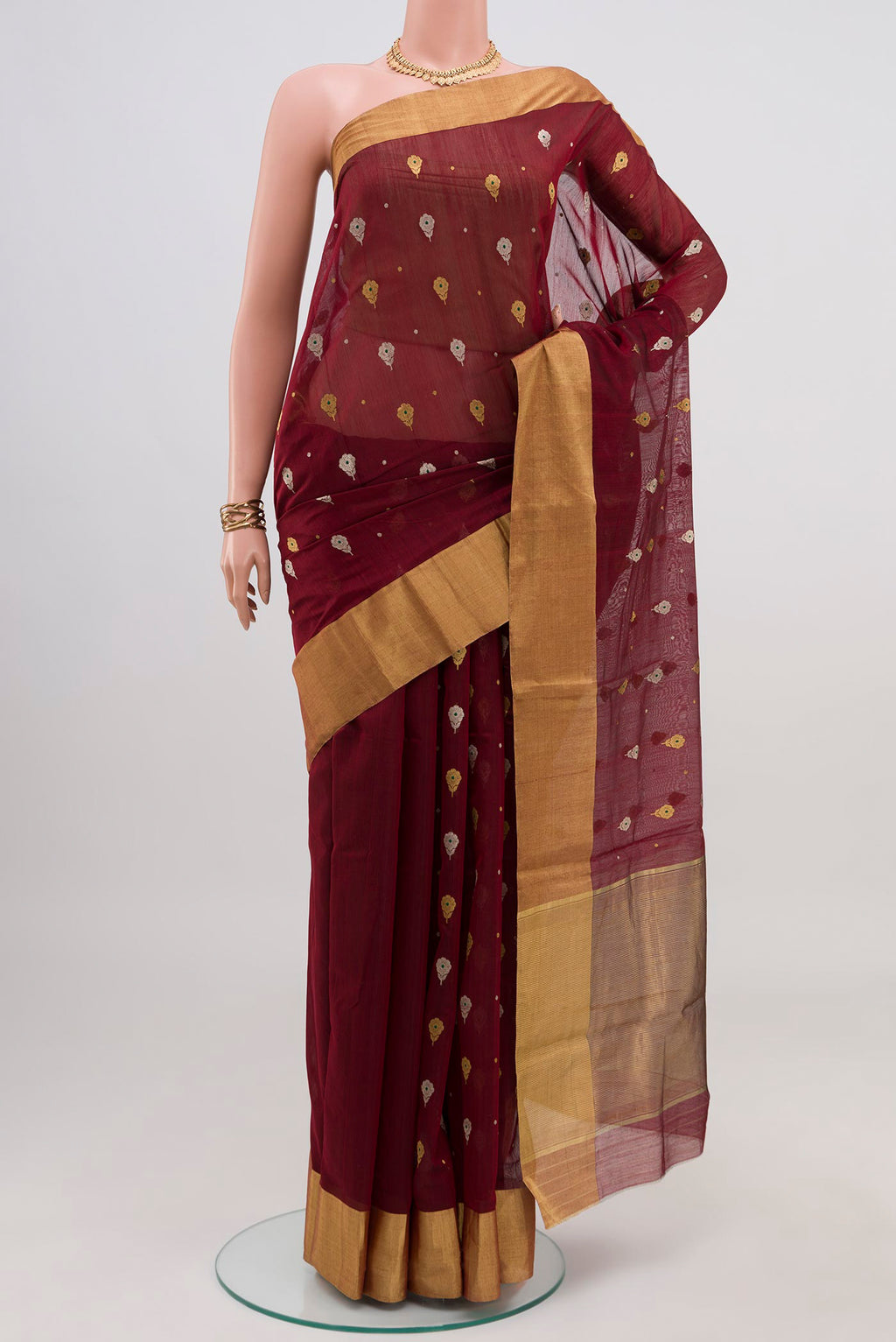 Maroon Chanderi Silk Cotton Saree with Zari Butta on the body and Zari Border.  displayed on a mannequin