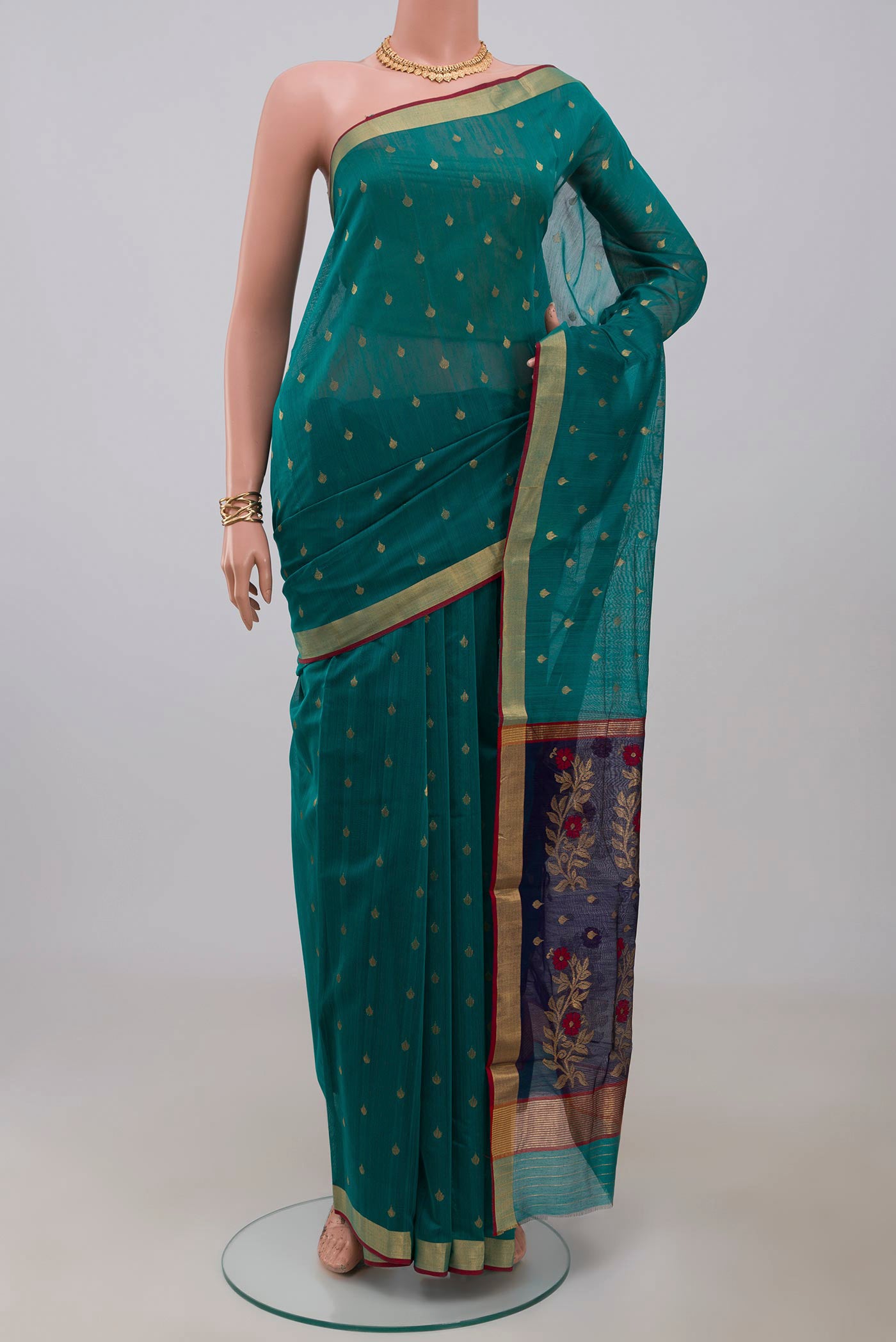 Green Chanderi Silk Cotton Saree with Zari Butta on the body and Zari Border.  displayed on a mannequin