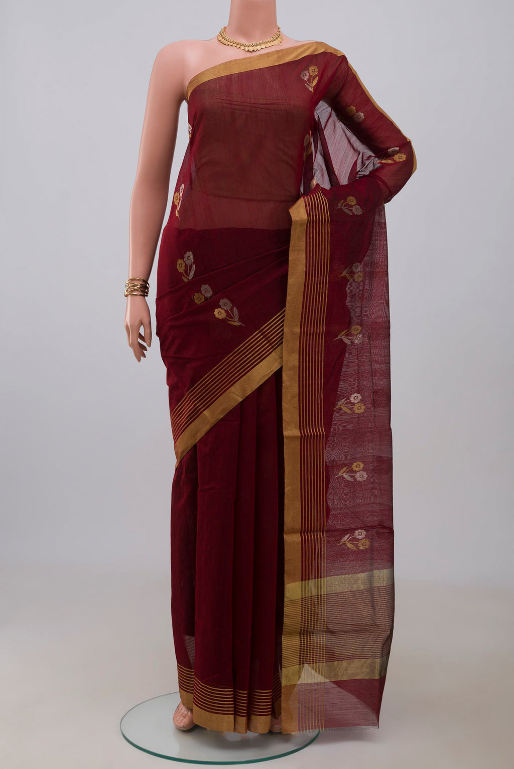 Maroon Chanderi Silk Cotton Saree with Zari Butta on the body and Zari Border.  displayed on a mannequin