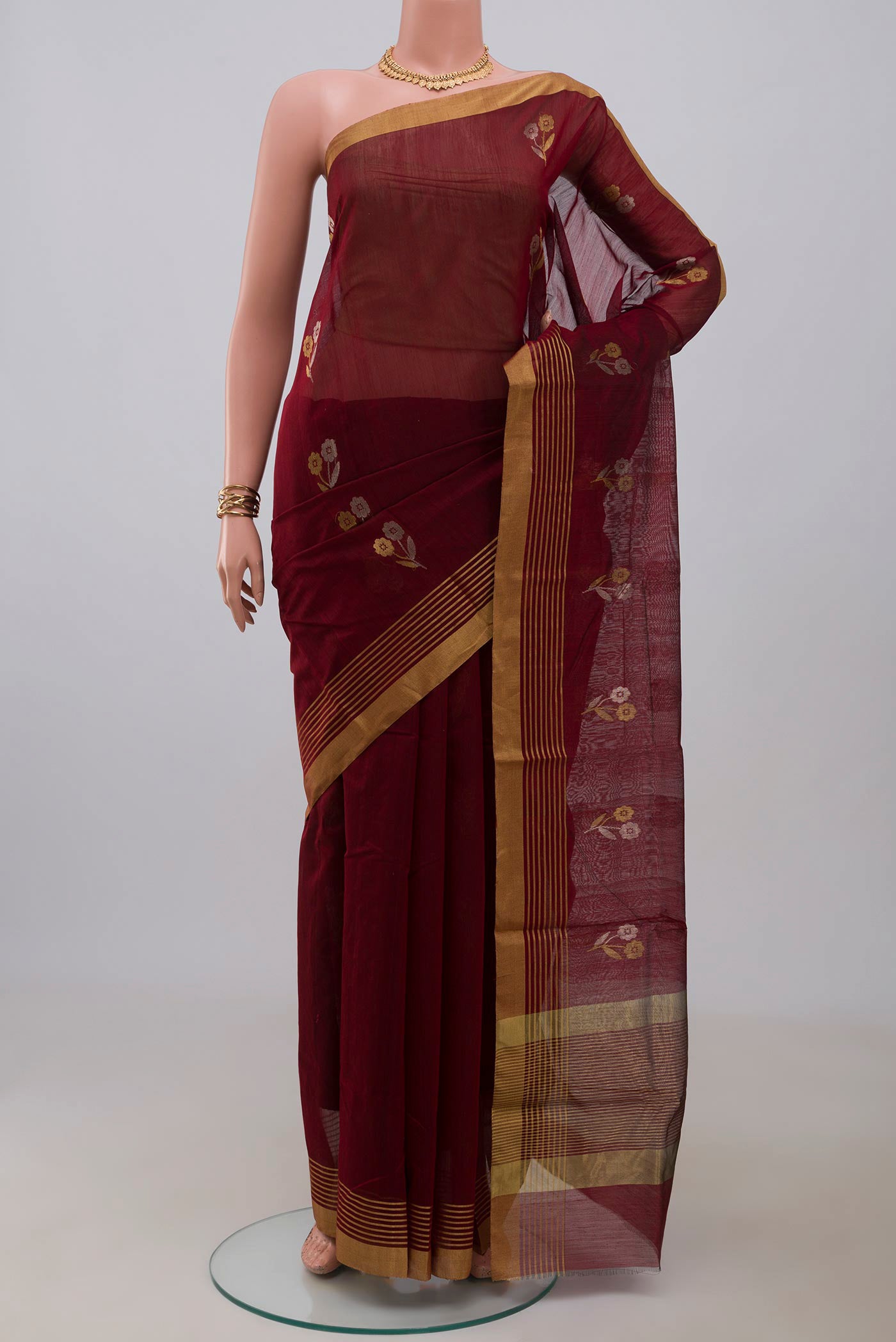Maroon Chanderi Silk Cotton Saree with Zari Butta on the body and Zari Border.  displayed on a mannequin