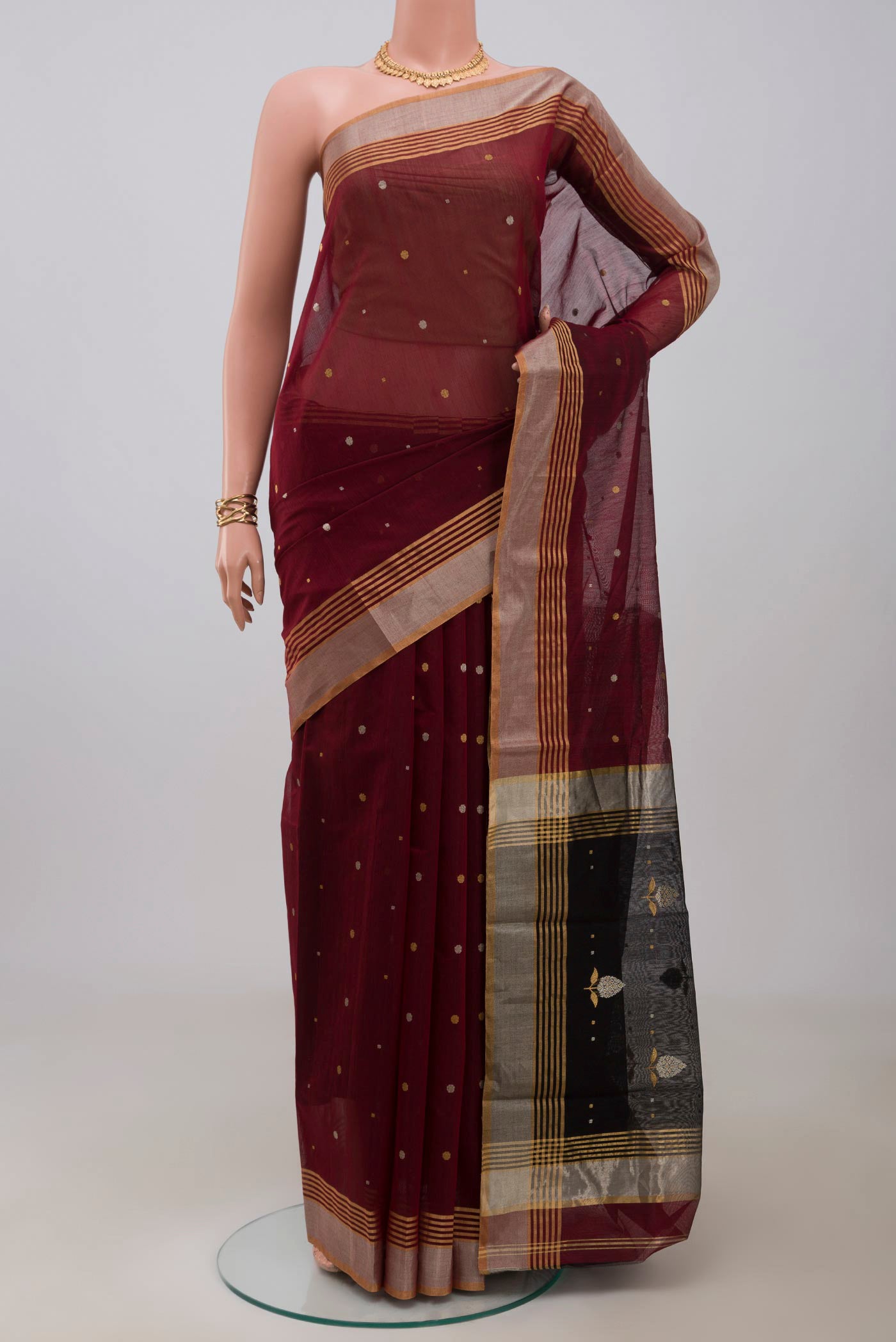 Maroon Chanderi Silk Cotton Saree with Zari Butta on the body and Zari Border.  displayed on a mannequin