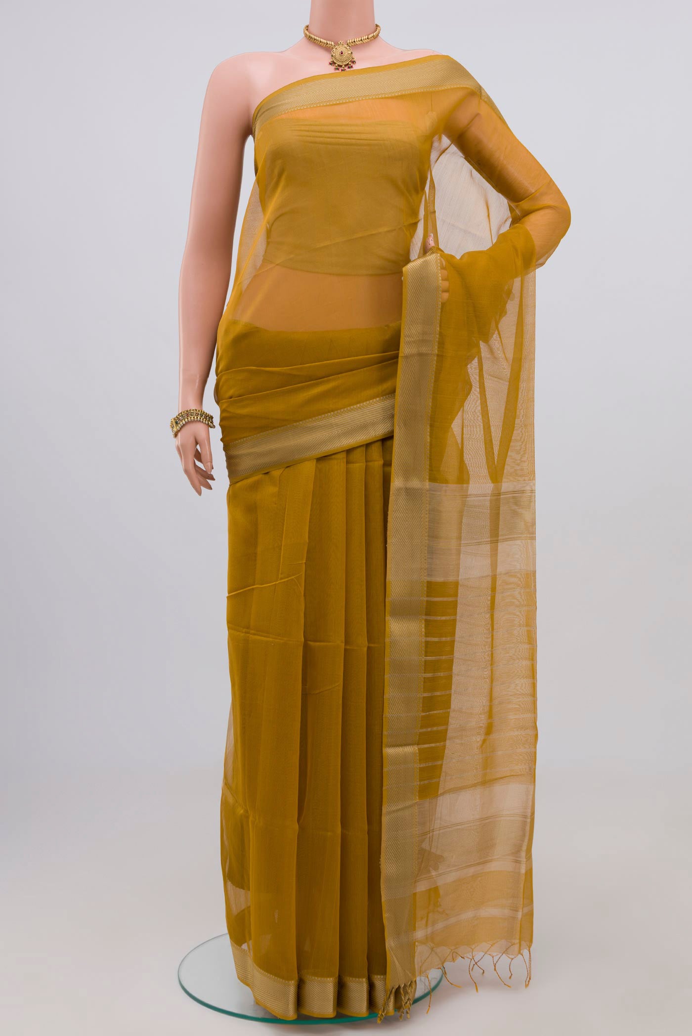 Mustard Maheshwari Silk Cotton Saree with Plain Body and Thread Border.  displayed on a mannequin