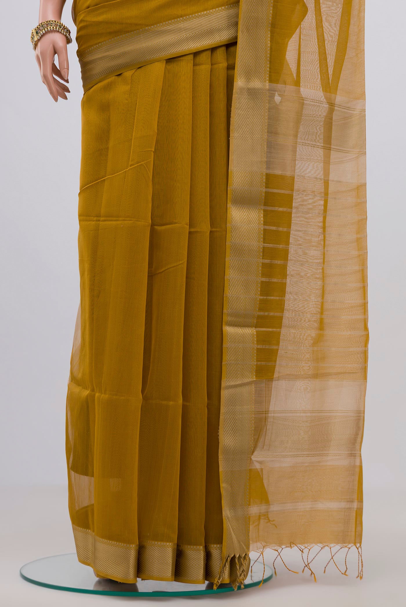 Pleats and pallu of Mustard Maheshwari Silk Cotton Saree with Plain Body and Thread Border. 
