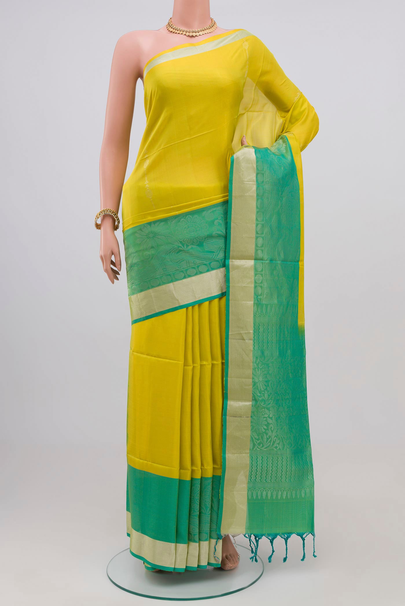 Parrot Green Soft Silk Saree with Stripes on the body and Zari Border.  displayed on a mannequin