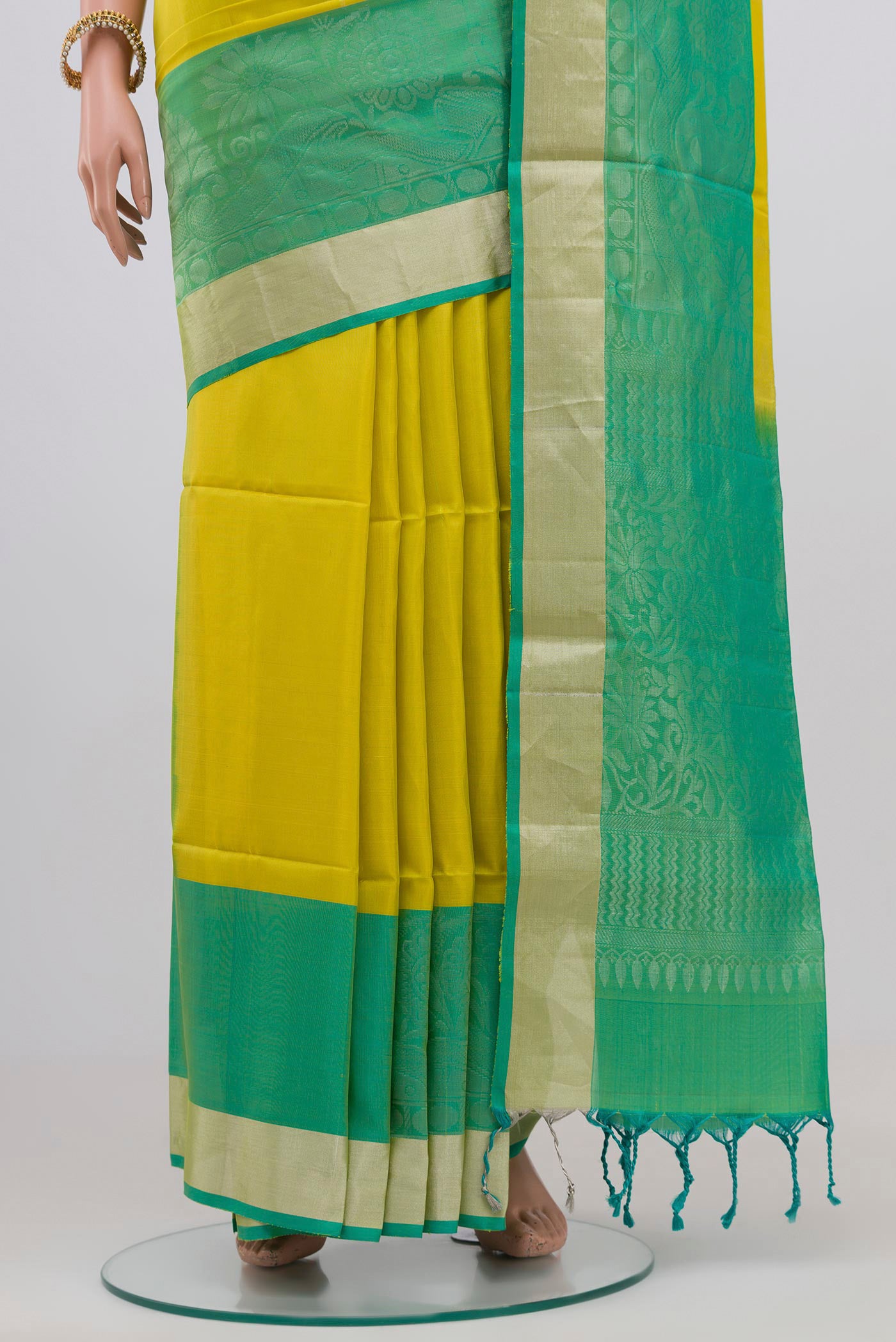 Pleats and pallu of Parrot Green Soft Silk Saree with Stripes on the body and Zari Border. 