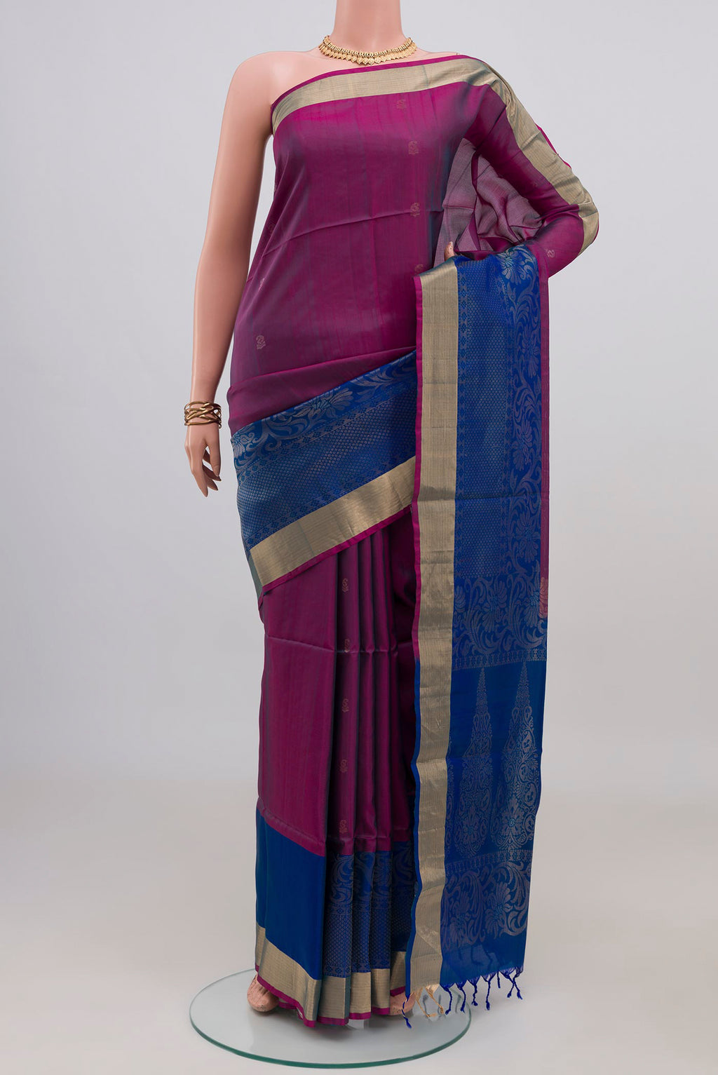 Purple Soft Silk Saree with Zari Butta on the body and Fancy Border.  displayed on a mannequin