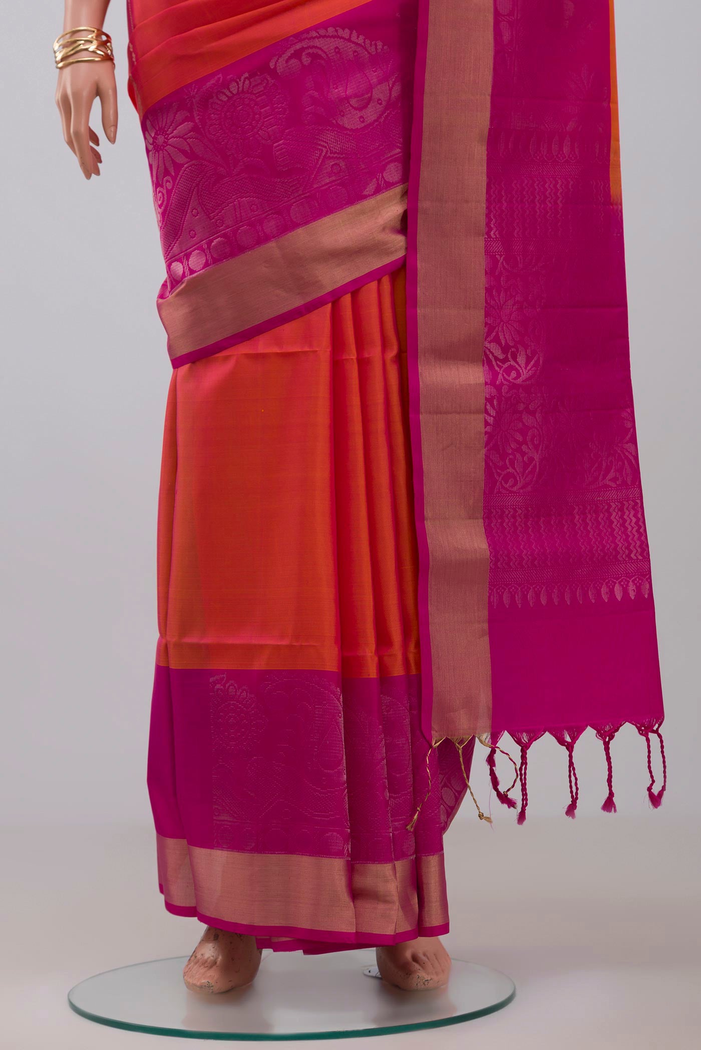 Pleats and pallu of Orange Soft Silk Saree with Fancy on the body and Fancy Border. 