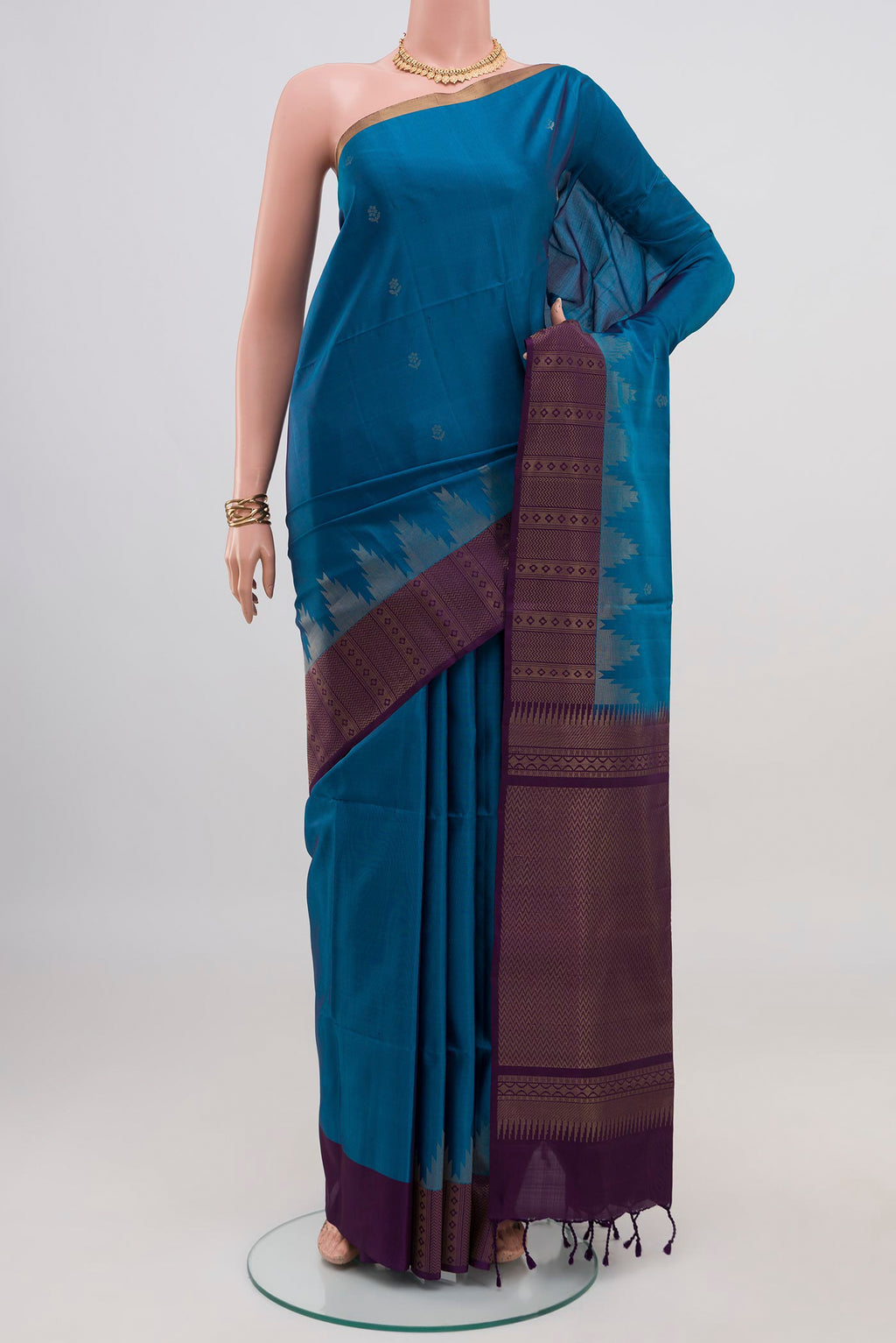 Blue Soft Silk Saree with Zari Butta on the body and Fancy Border.  displayed on a mannequin