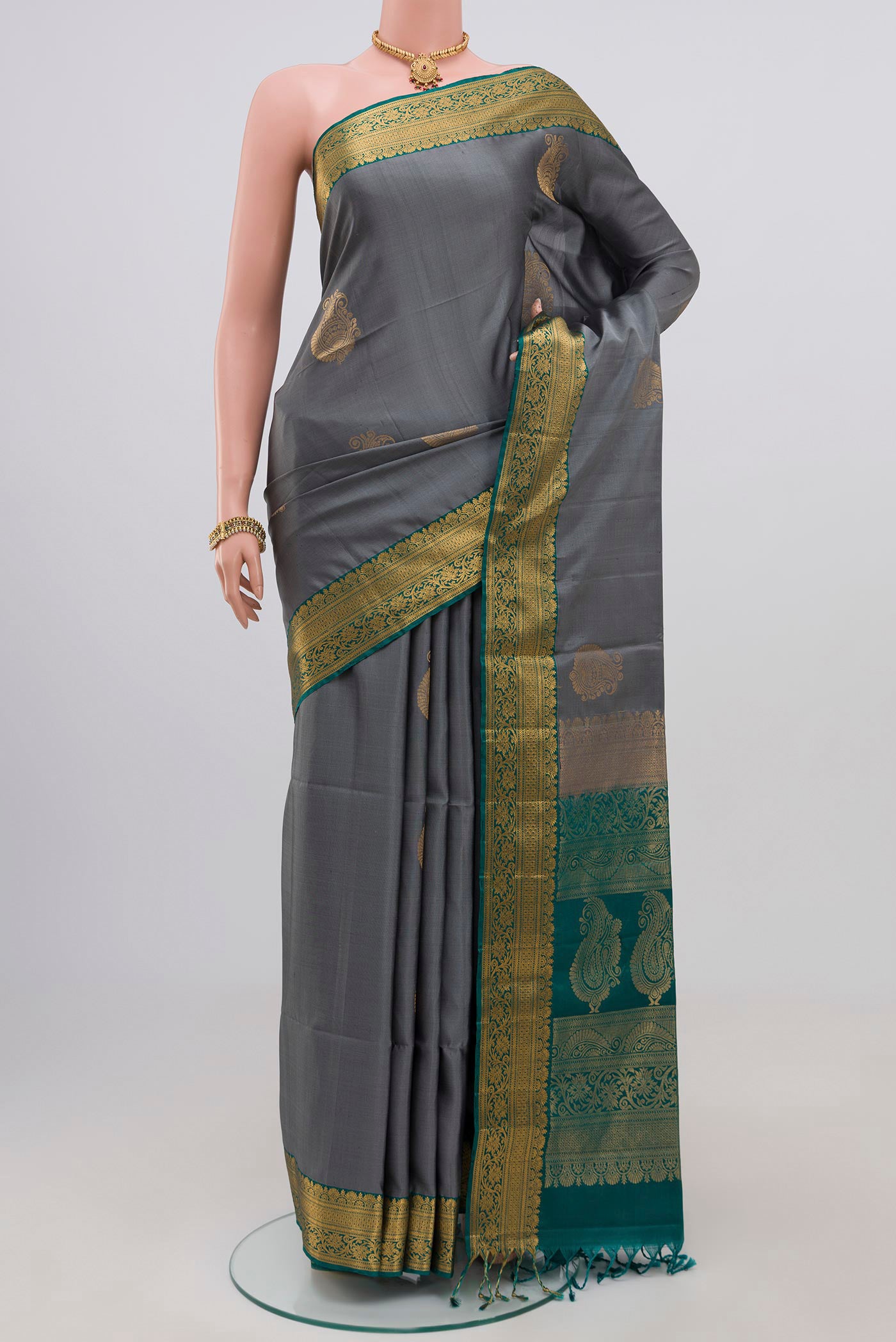 Grey Soft Silk Saree with Zari Butta on the body and Zari Border.  displayed on a mannequin