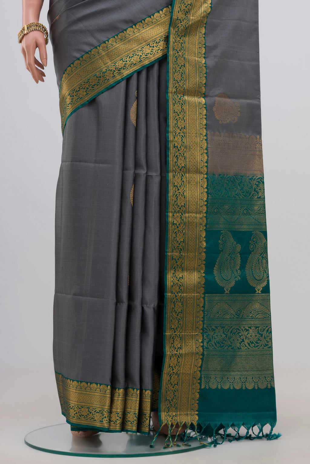 Pleats and pallu of Grey Soft Silk Saree with Zari Butta on the body and Zari Border. 