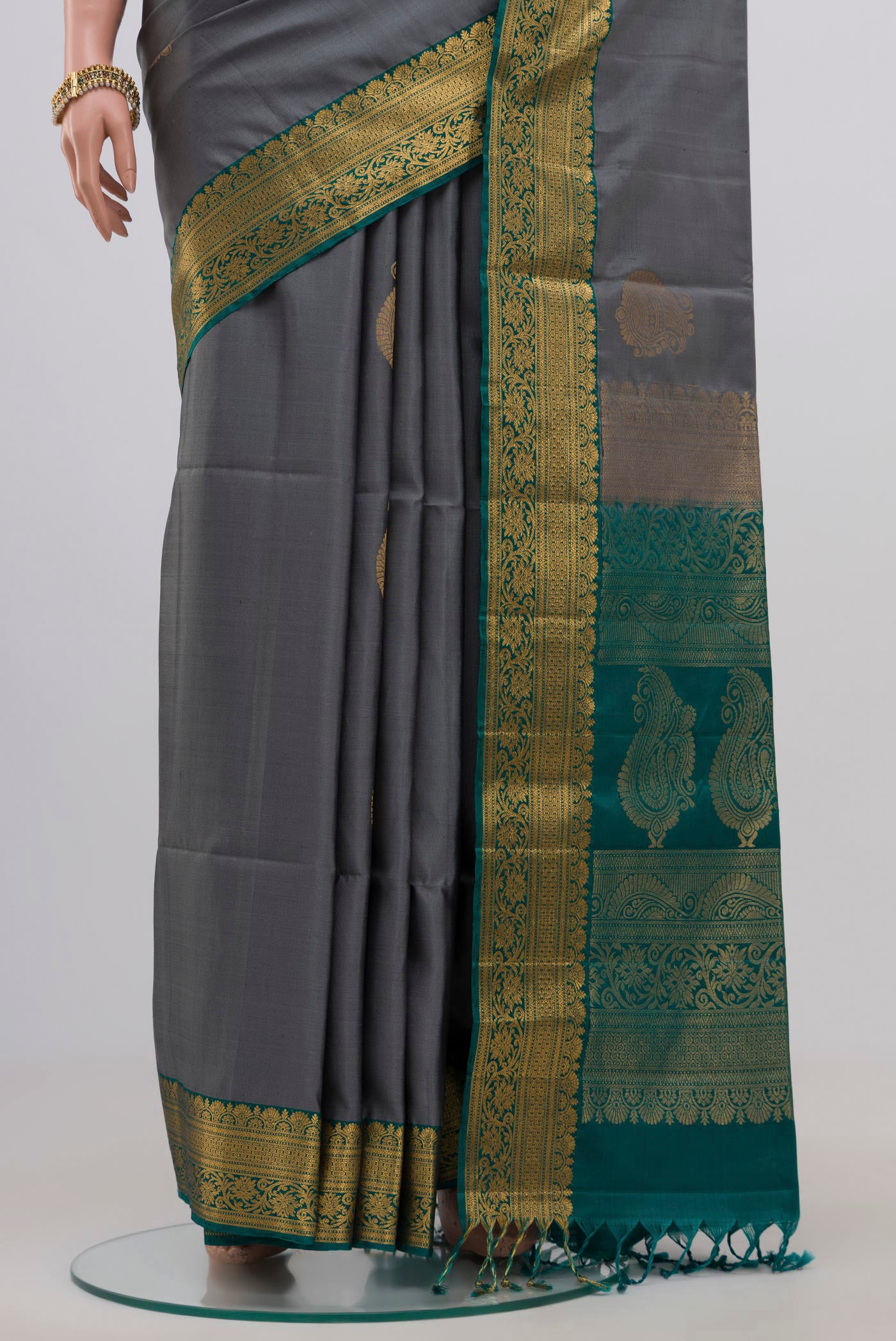 Pleats and pallu of Grey Soft Silk Saree with Zari Butta on the body and Zari Border. 