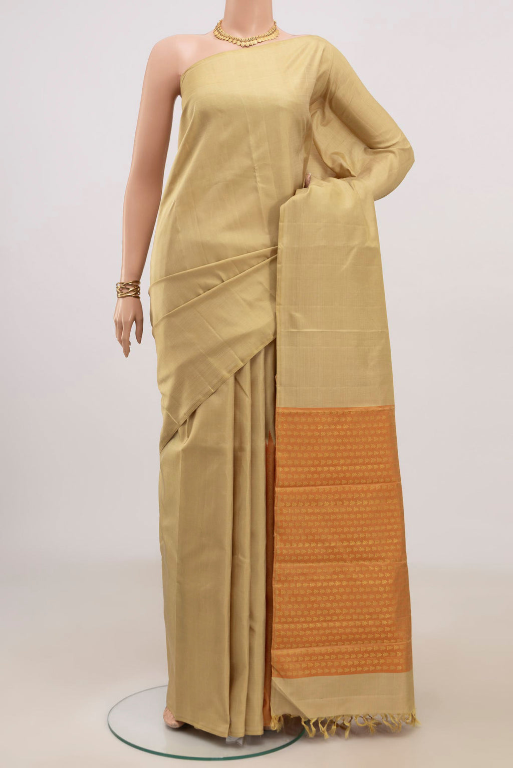Beige Kanjivaram Silk Saree with Fancy on the body and Without Border.  displayed on a mannequin