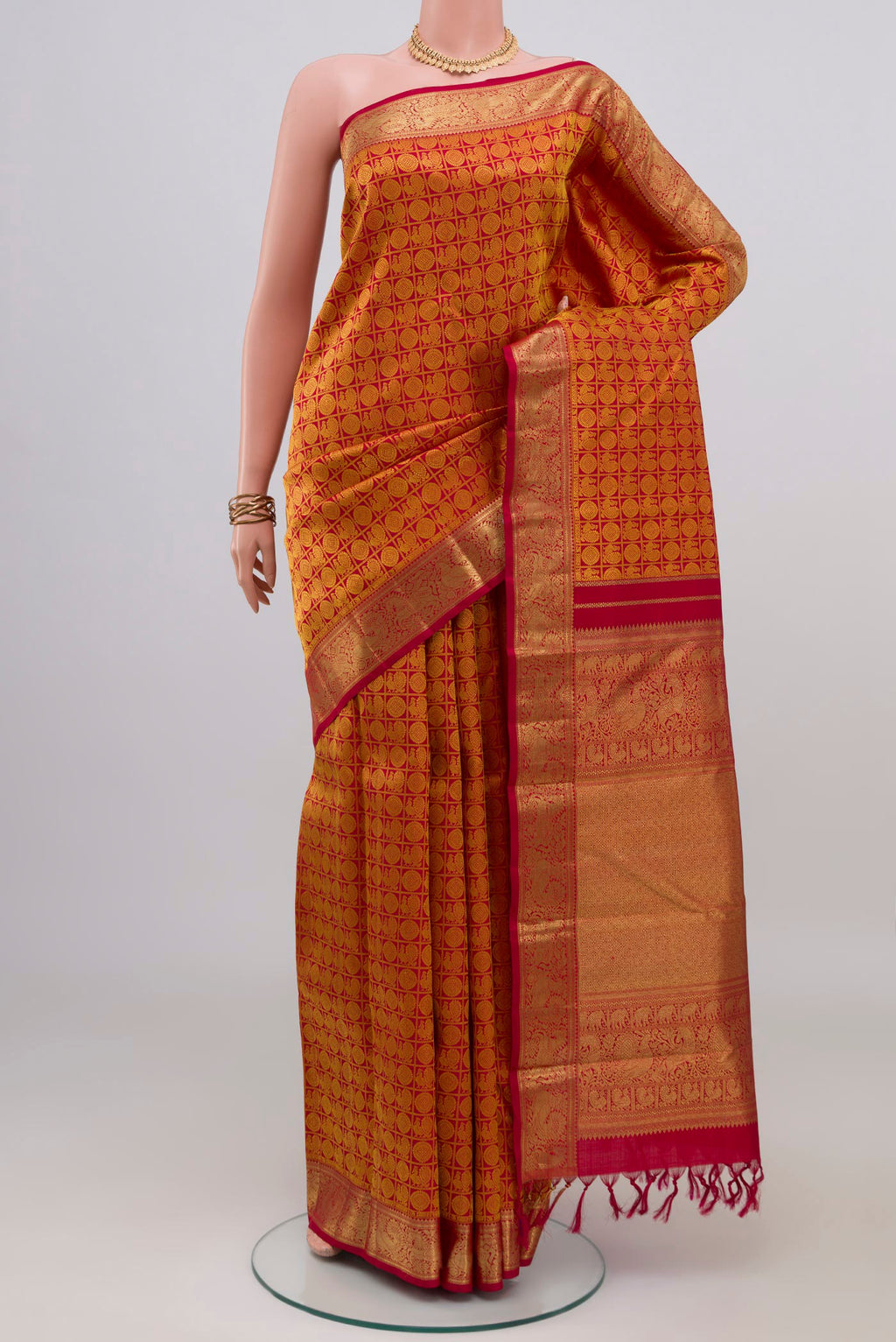 Maroon Kanjivaram Silk Saree with Jacquard design on the body and Zari Border.  displayed on a mannequin