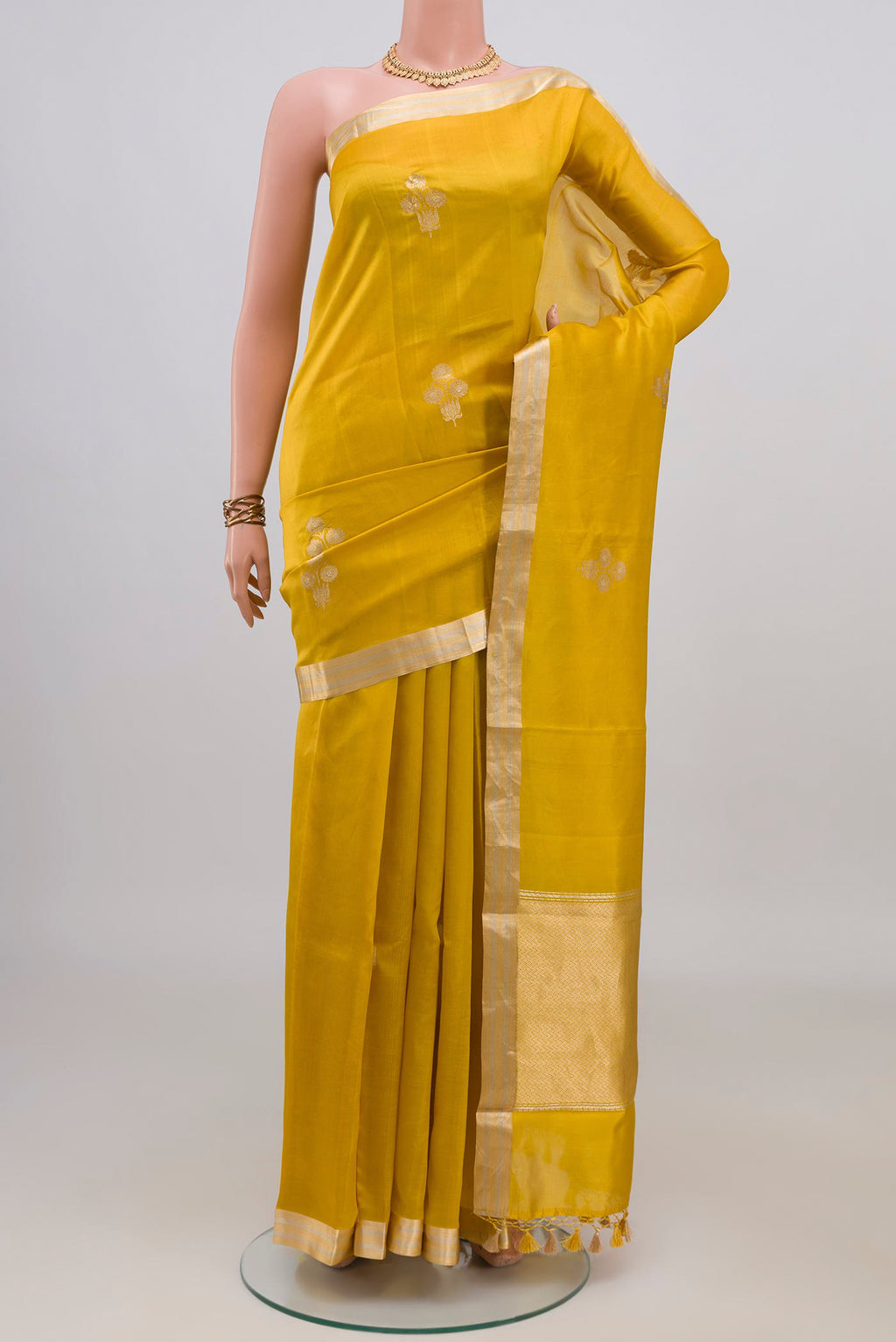 Pure Silk Yellow Banarasi Katan Saree with Zari Butta on the body and Zari Border.  displayed on a mannequin