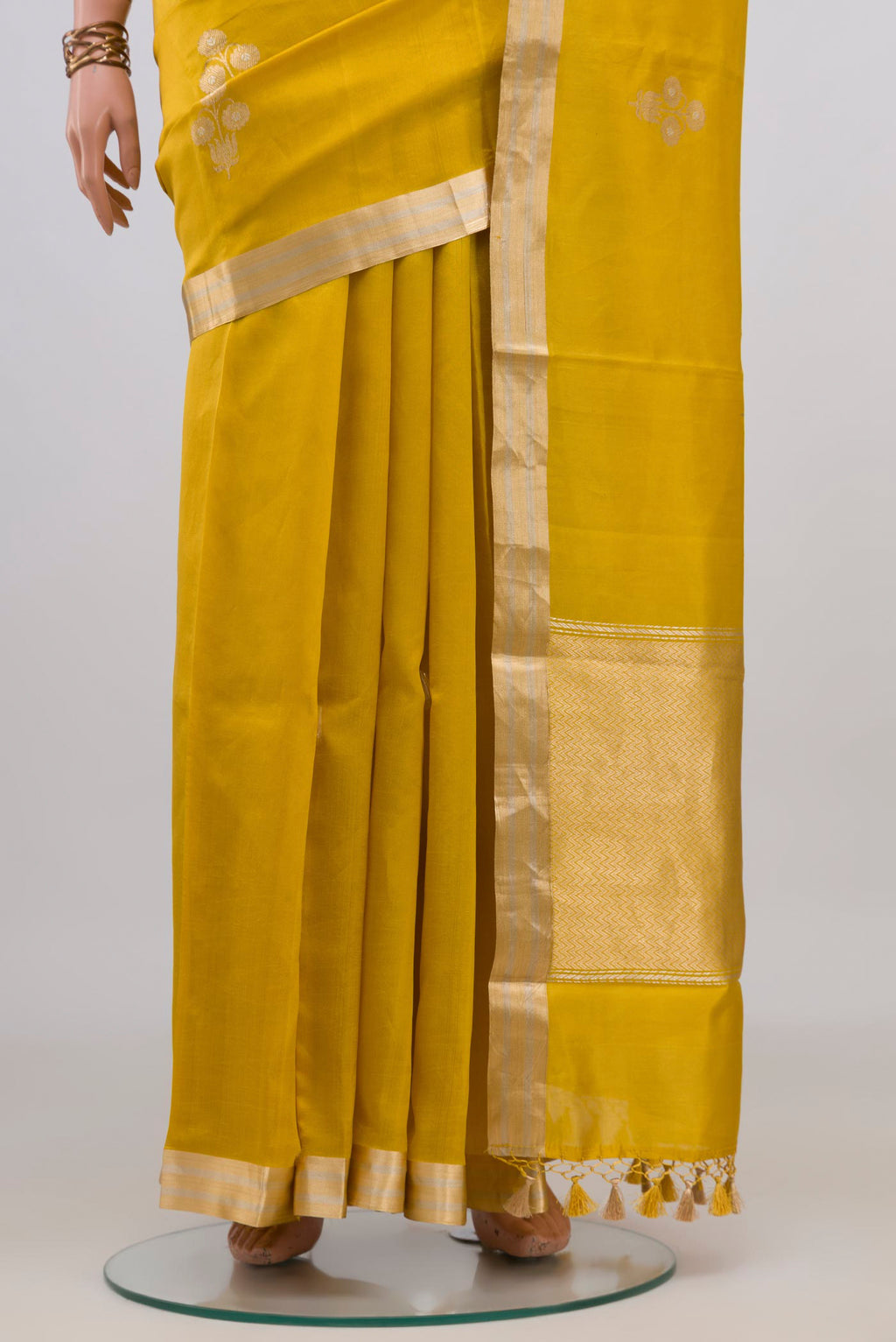 Pleats and pallu of Pure Silk Yellow Banarasi Katan Saree with Zari Butta on the body and Zari Border. 