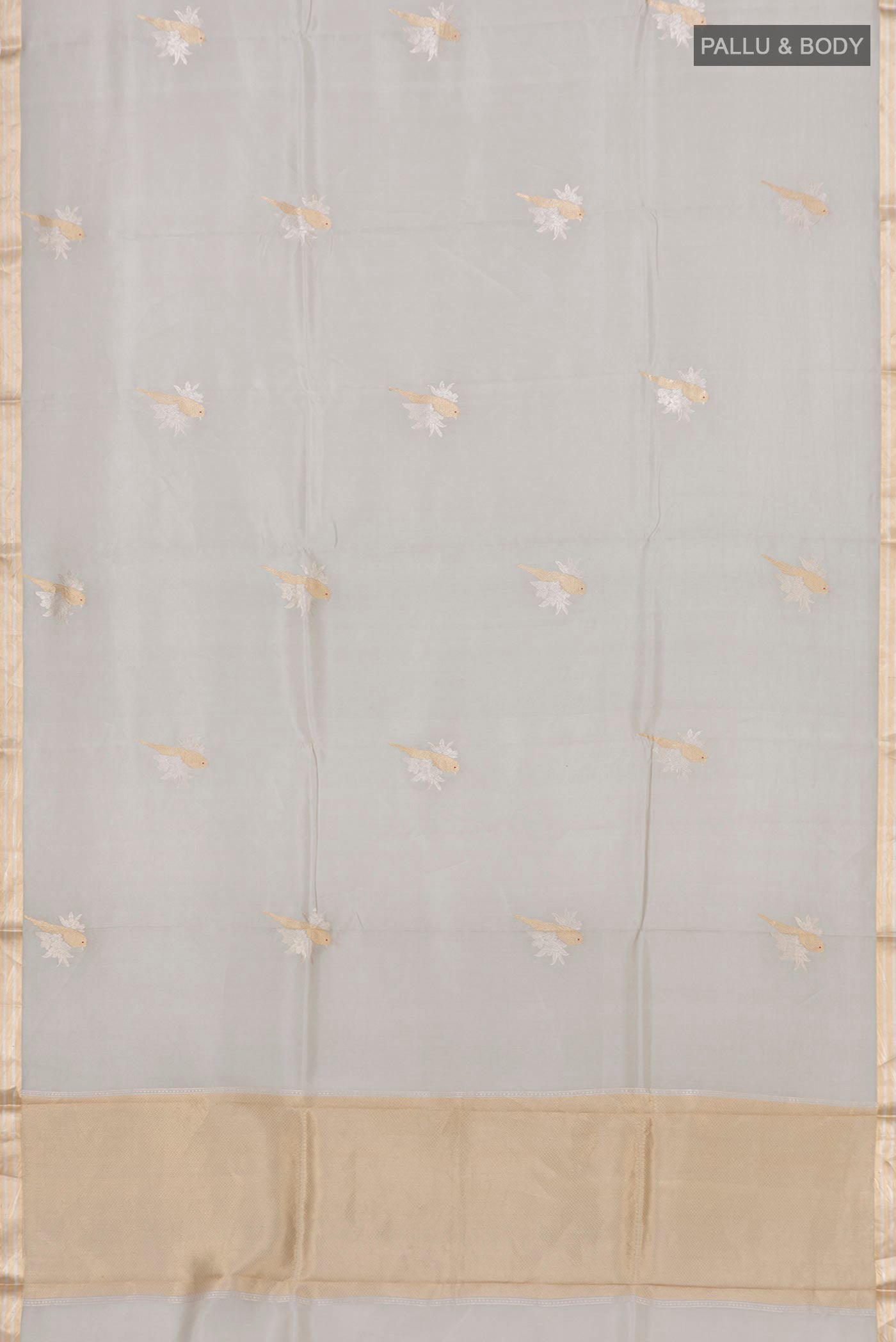 Flat view of Grey Banarasi Katan Silk Saree with Zari Butta on the body and Zari Border. 