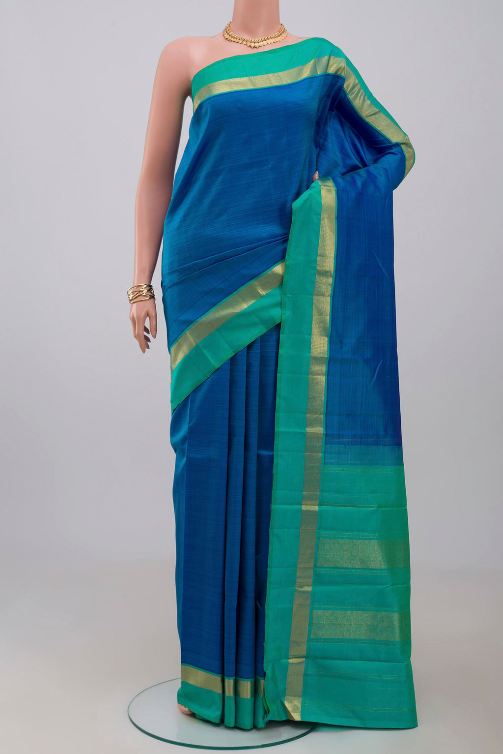 Pure Silk Pure Zari Blue Kanjivaram Saree with Plain Body and Zari Border.  displayed on a mannequin