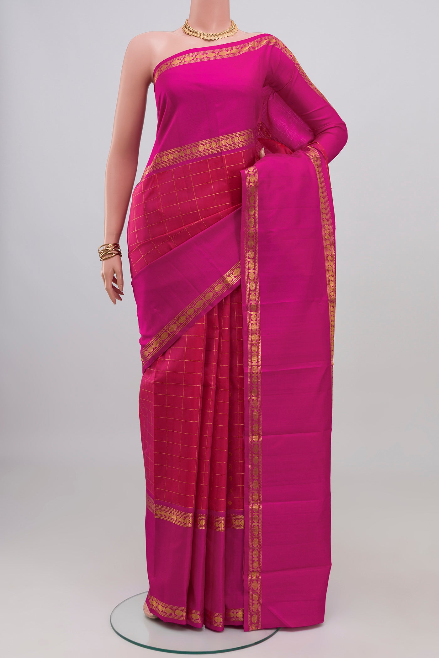 Pink Kanjivaram Silk Saree with Checked design on the body and Zari Border.  displayed on a mannequin