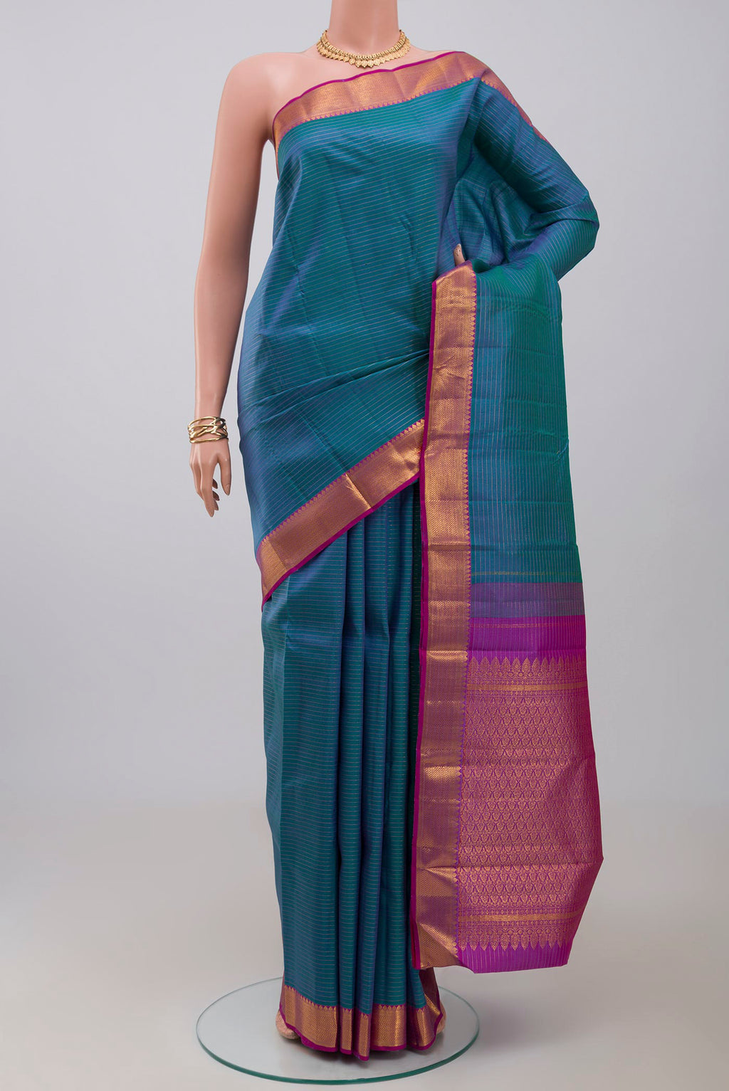 Blue Kanchipuram Silk Saree with Stripes on the body and Zari Border.  displayed on a mannequin