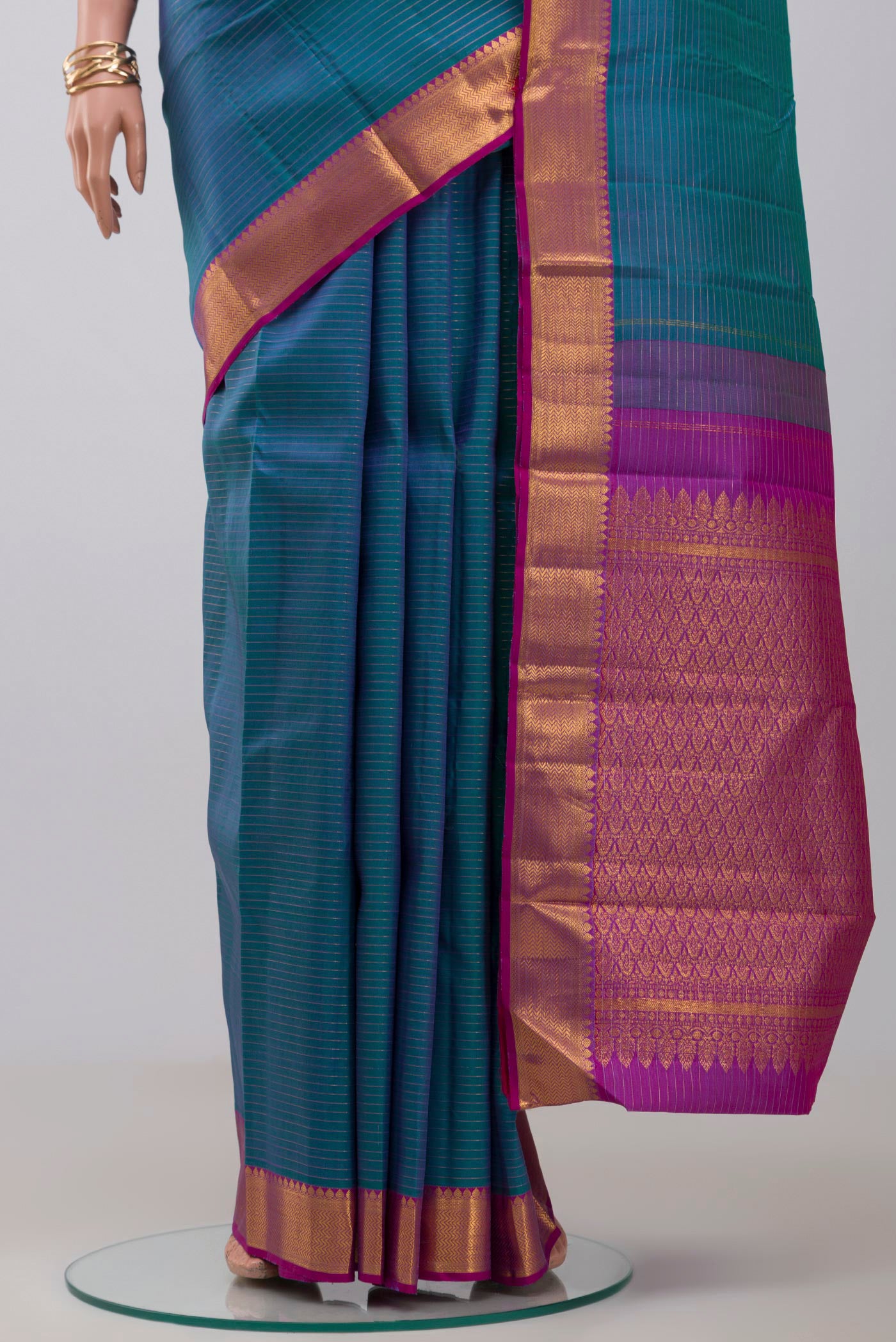 Pleats and pallu of Blue Kanchipuram Silk Saree with Stripes on the body and Zari Border. 