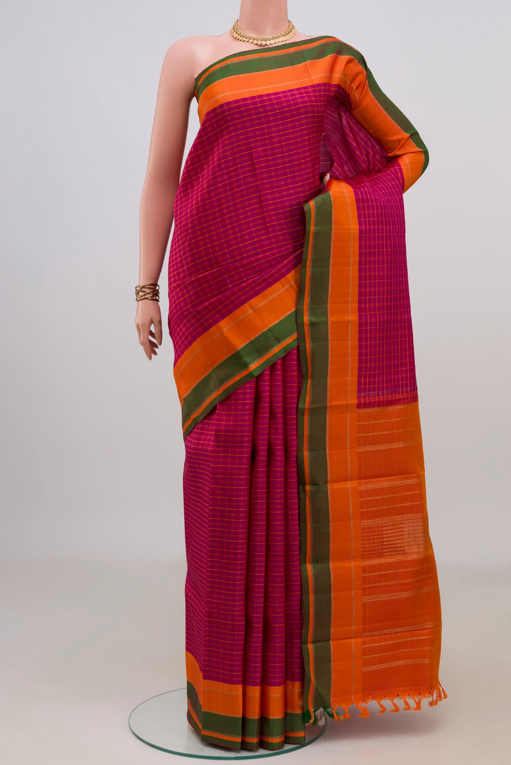 Pure Silk Pure Zari Pink Kanjivaram Saree with Checked design on the body and Plain Border.  displayed on a mannequin