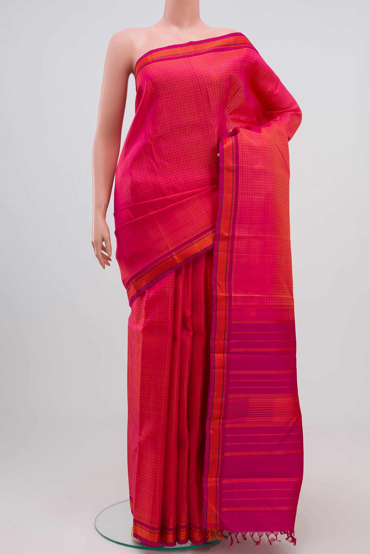 Orange Dual Tone Kanjivaram Silk Saree with Thread Brocade on the body and Thread Border.  displayed on a mannequin
