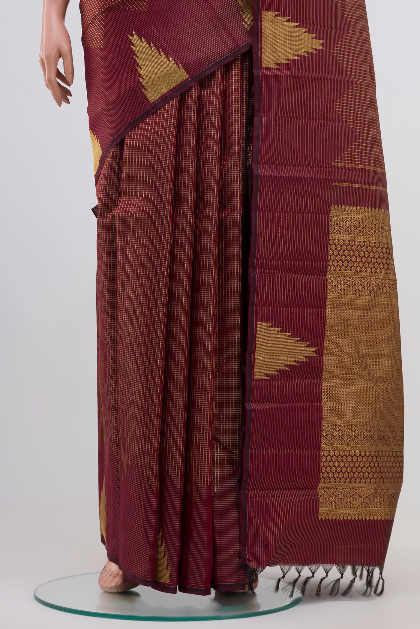 Pleats and pallu of Maroon Kanjivaram Silk Saree with Zari Brocade on the body and Temple Border. 