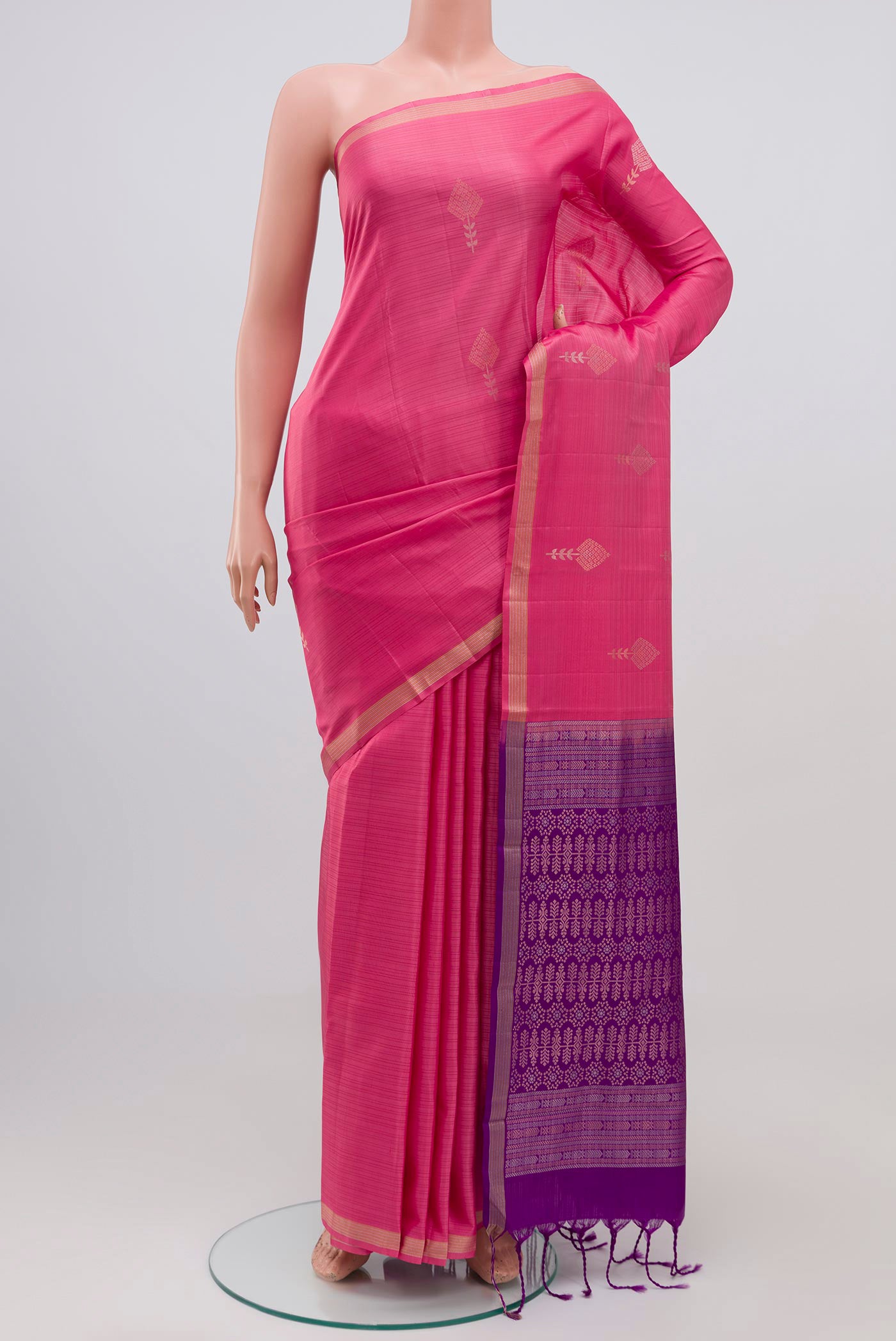 Pink Kanjivaram Silk Saree with Zari Butta on the body and Zari Border.  displayed on a mannequin