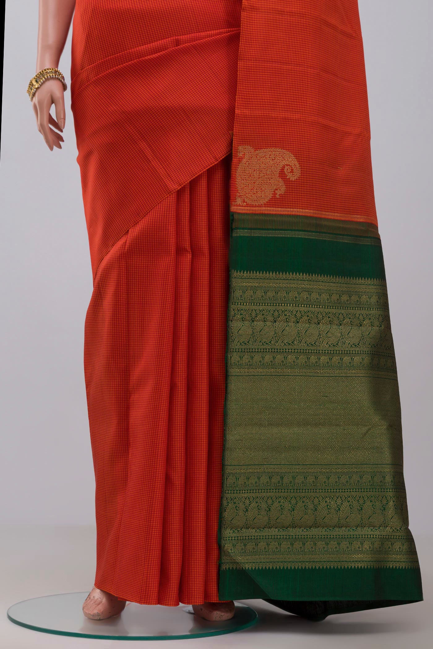 Pleats and pallu of Pure Silk Pure Zari Orange Kanchipuram Saree with Checked design on the body and Without Border. 