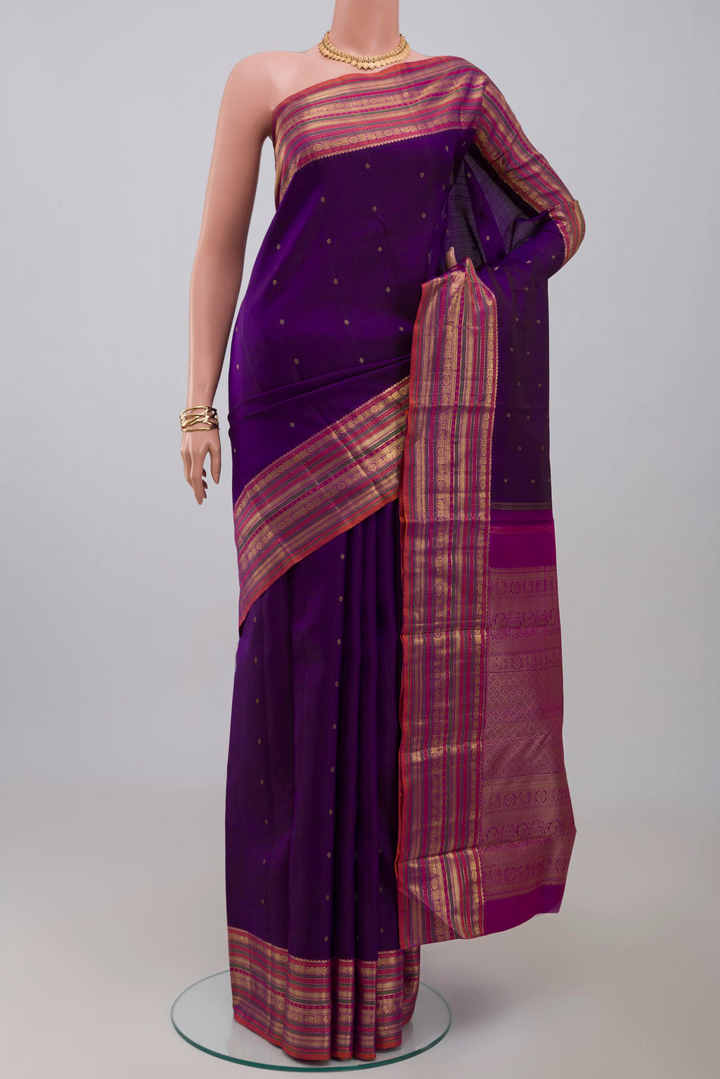 Pure Silk Pure Zari Purple Kanjivaram Saree with Zari Butta on the body and Zari Border.  displayed on a mannequin