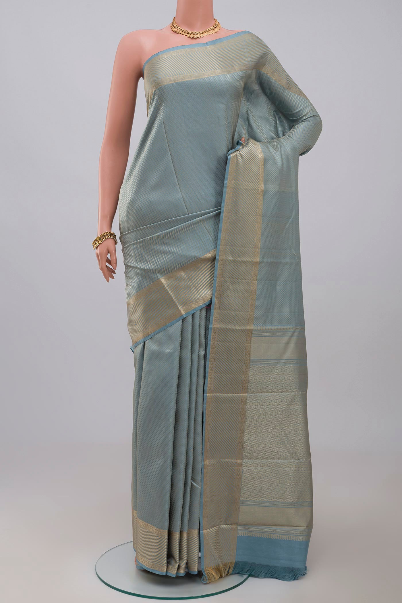 Sky Blue Kanchipuram Silk Saree with Jacquard design on the body and Thread Border.  displayed on a mannequin