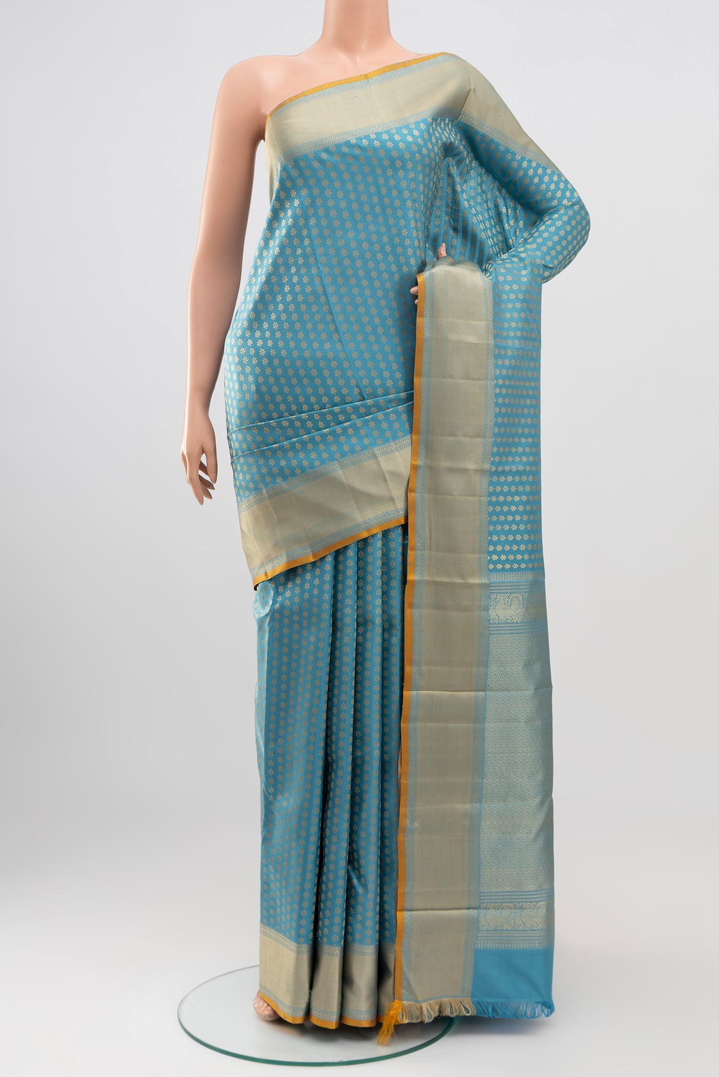 Blue Kanchipuram Silk Saree with Thread Butta on the body and Thread Border.  displayed on a mannequin