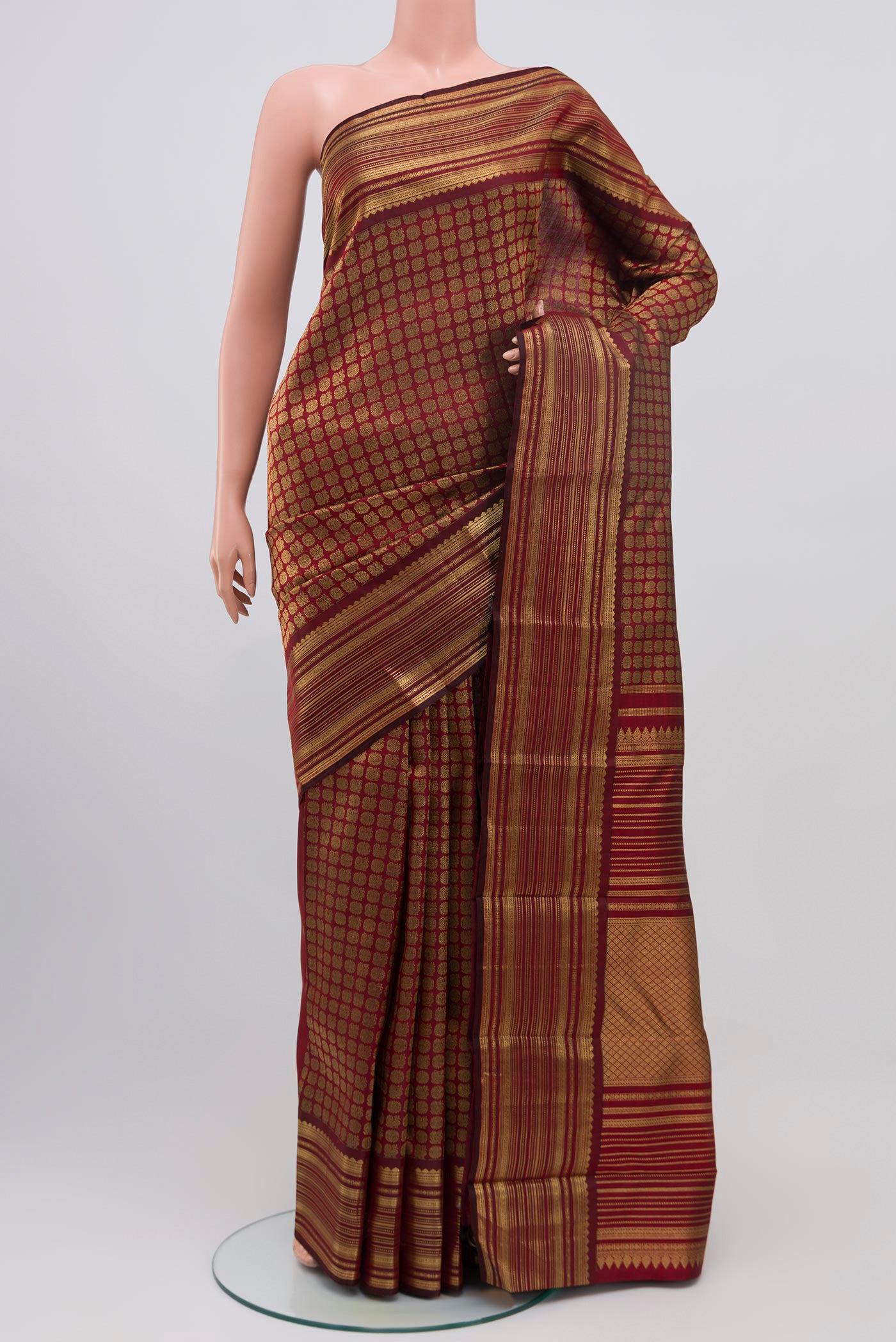 Pure Silk Pure Zari Maroon Kanjivaram Saree with Zari Brocade on the body and Zari Border.  displayed on a mannequin