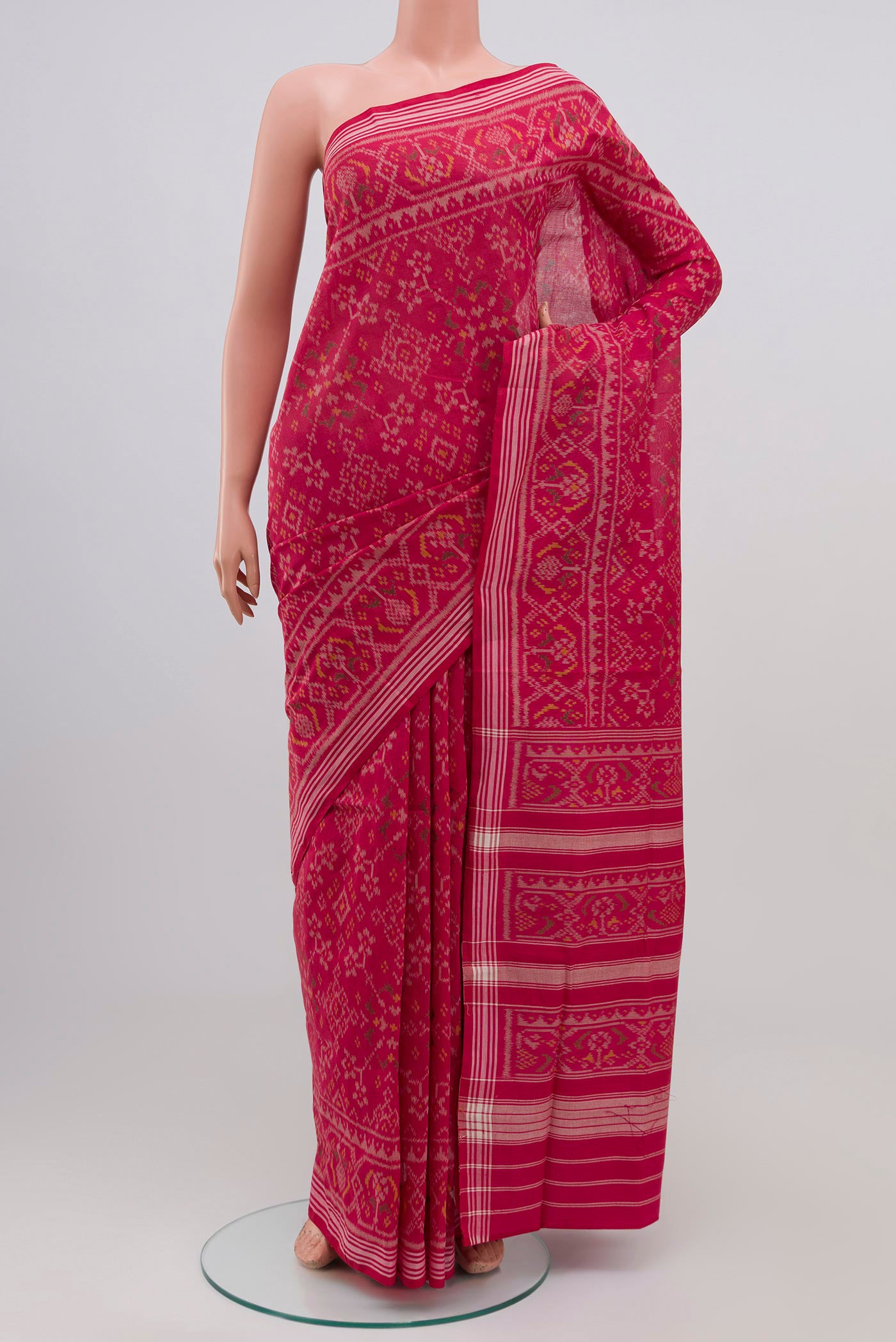 Pink Double Ikat Saree with Ikat design on the body and Plain Border.  displayed on a mannequin