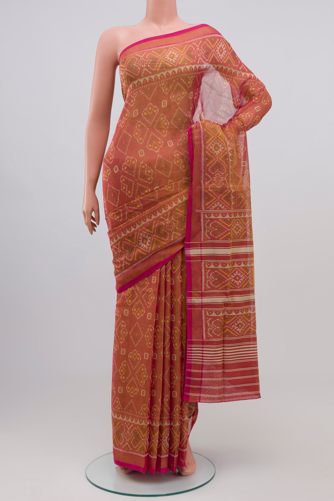 Golden Double Ikat Saree with Ikat design on the body and Zari Border.  displayed on a mannequin