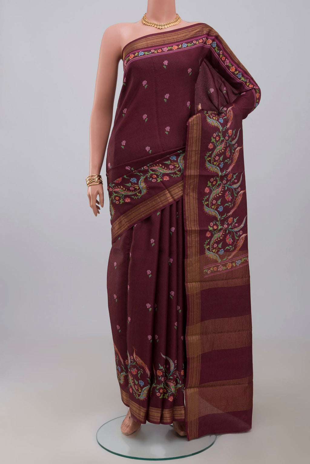 Brown Tussar Silk Saree with Printed design on the body and Zari Border.  displayed on a mannequin