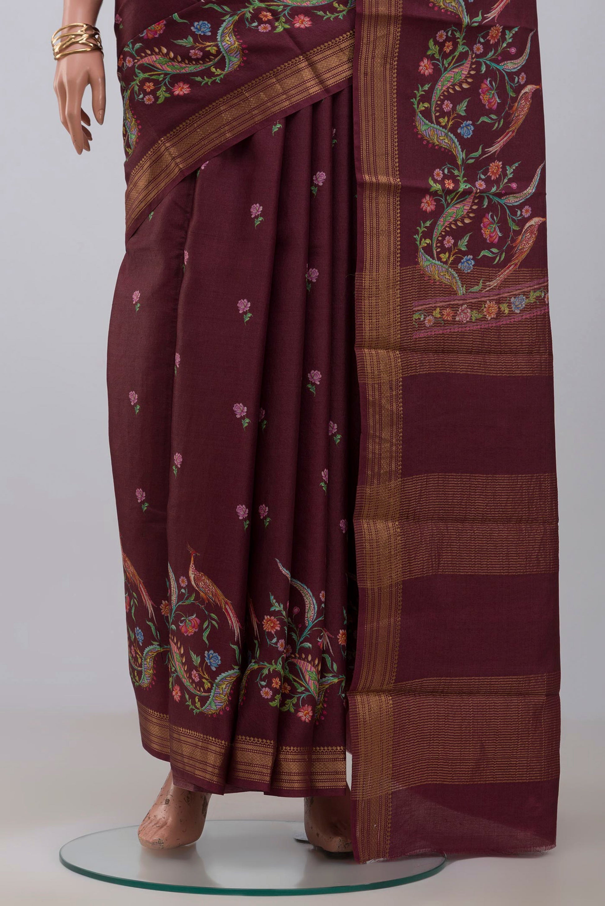 Pleats and pallu of Brown Tussar Silk Saree with Printed design on the body and Zari Border. 