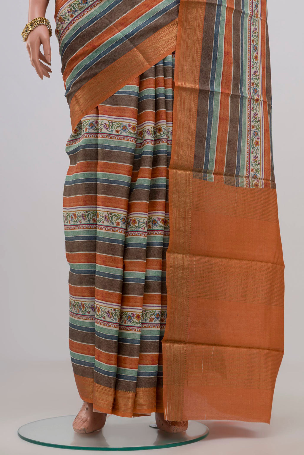 Pleats and pallu of Orange Tussar Silk Saree with Fancy on the body and Zari Border. 