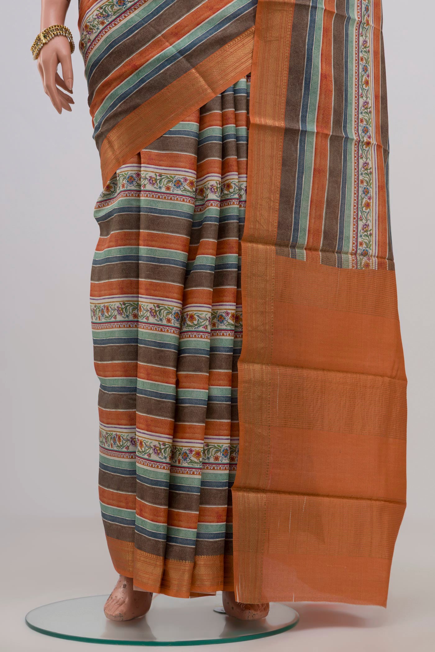 Pleats and pallu of Orange Tussar Silk Saree with Fancy on the body and Zari Border. 
