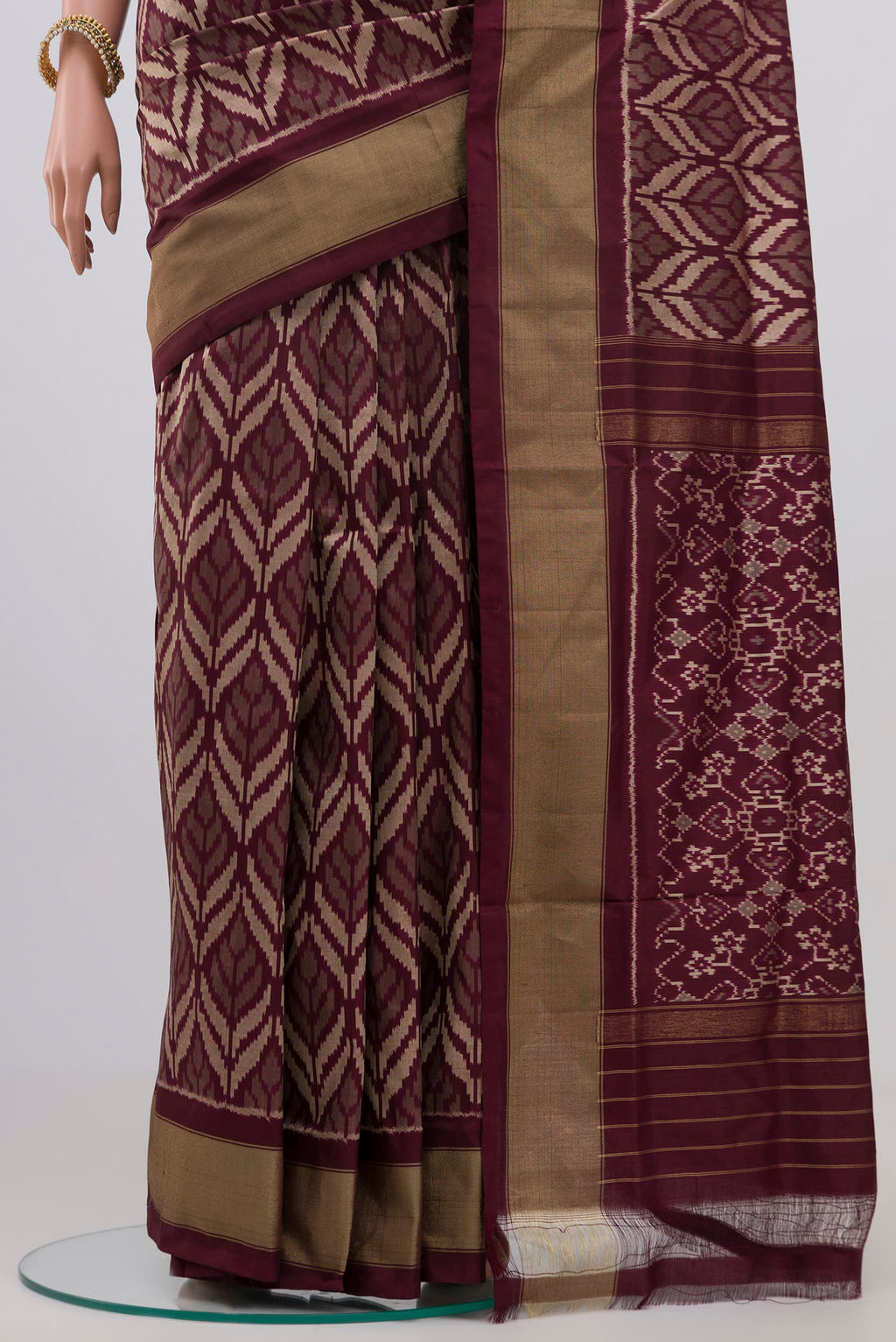 Pleats and pallu of Brown Pochampally Silk Saree with Ikat Print on the body and Zari Border. 