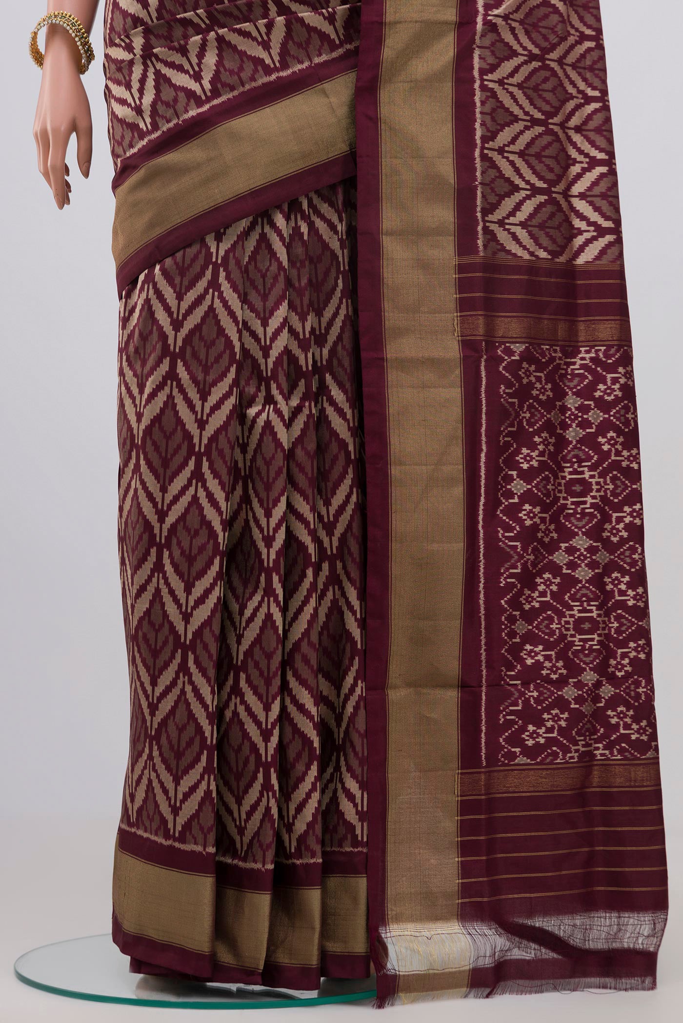 Pleats and pallu of Brown Pochampally Silk Saree with Ikat Print on the body and Zari Border. 