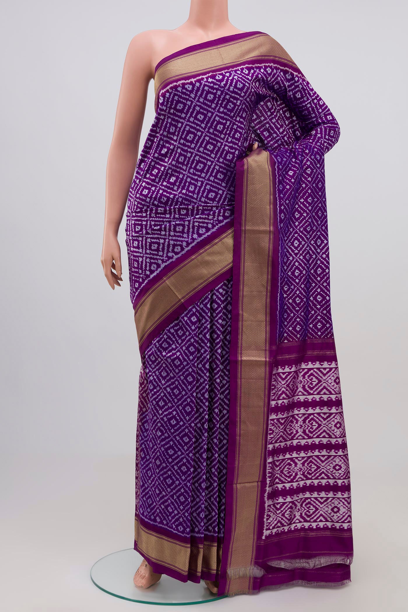 Purple Pochampally Silk Saree with Ikat Print on the body and Zari Border.  displayed on a mannequin