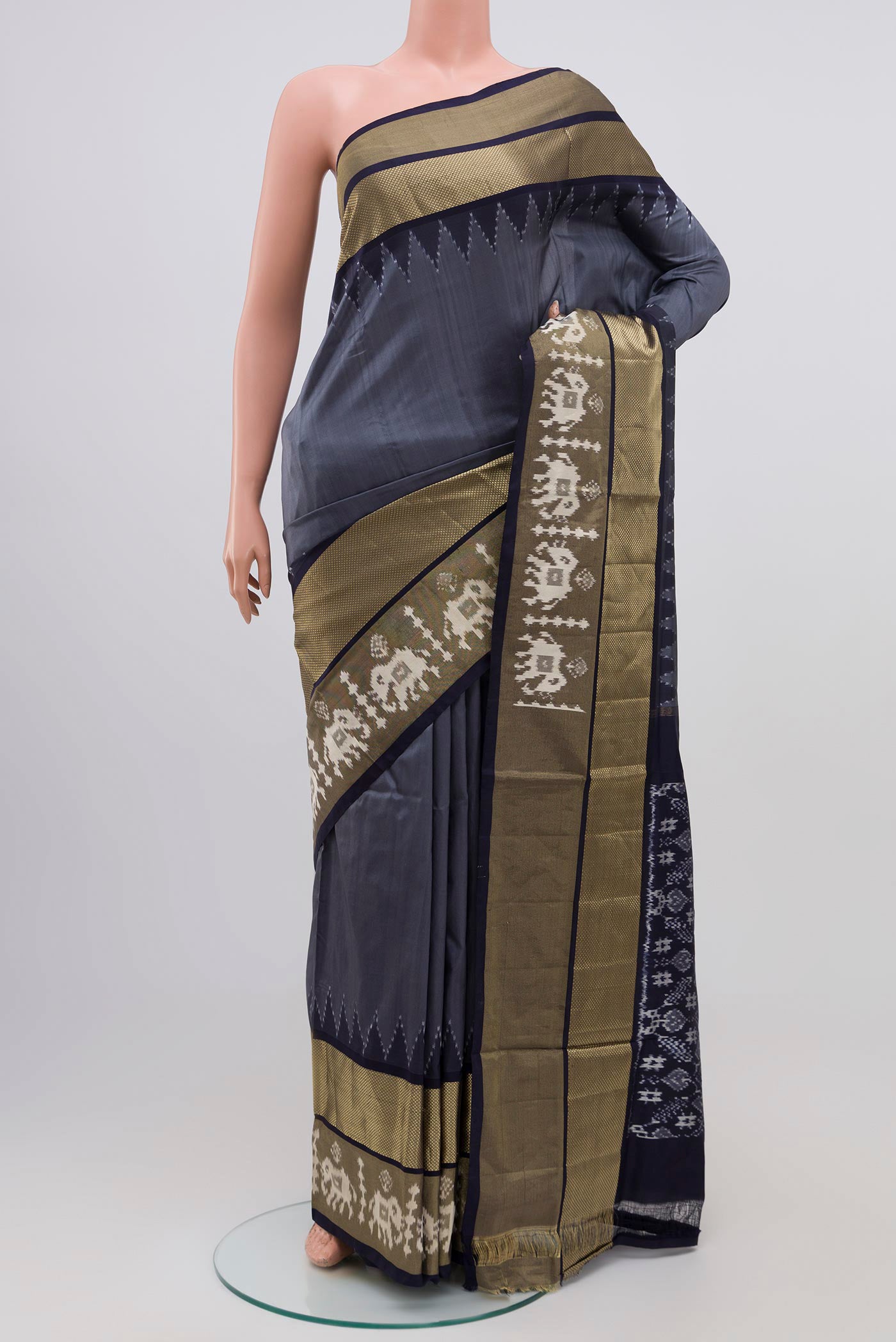 Grey Pochampally Silk Saree with Ikat design on the body and Zari Border.  displayed on a mannequin