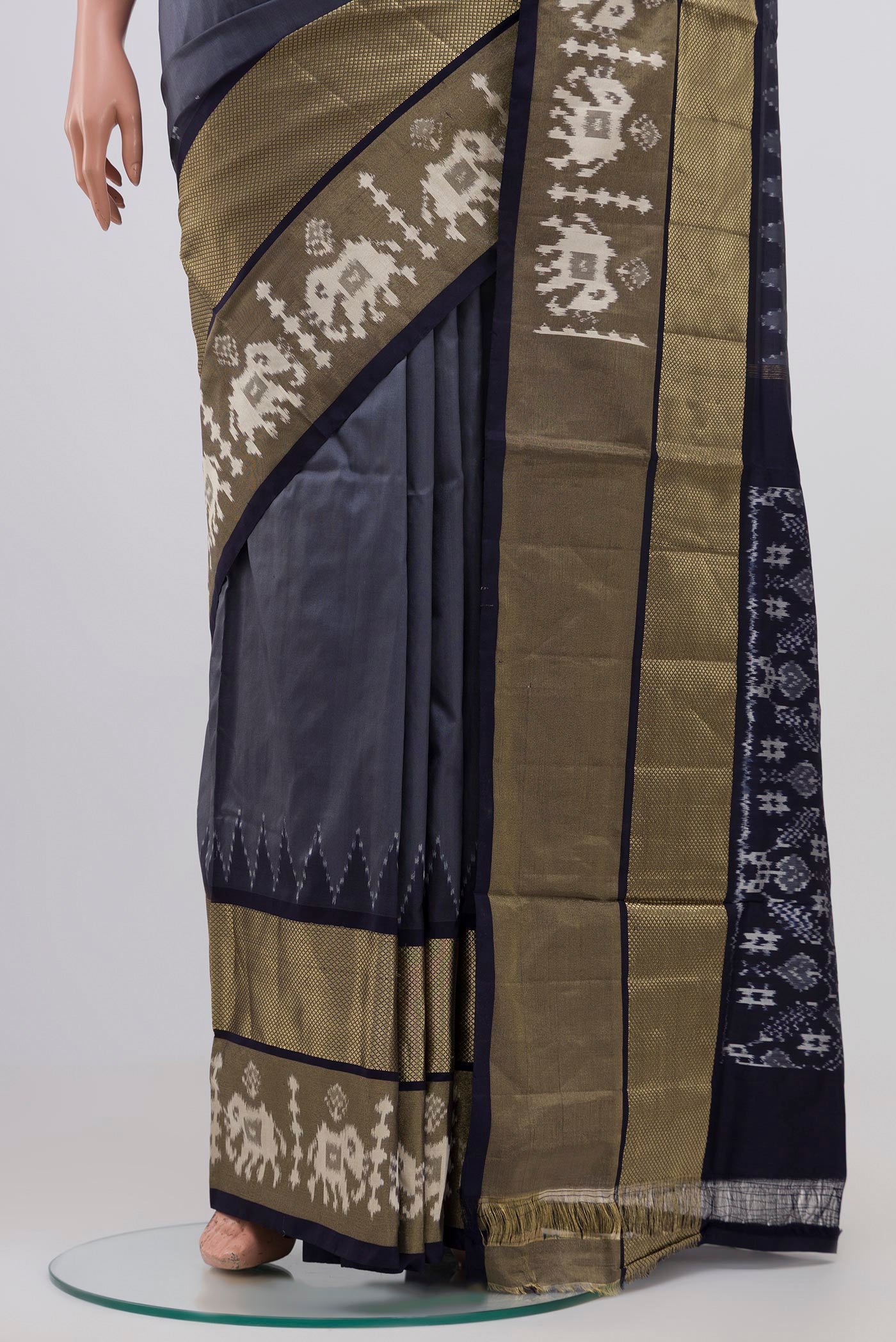 Pleats and pallu of Grey Pochampally Silk Saree with Ikat design on the body and Zari Border. 
